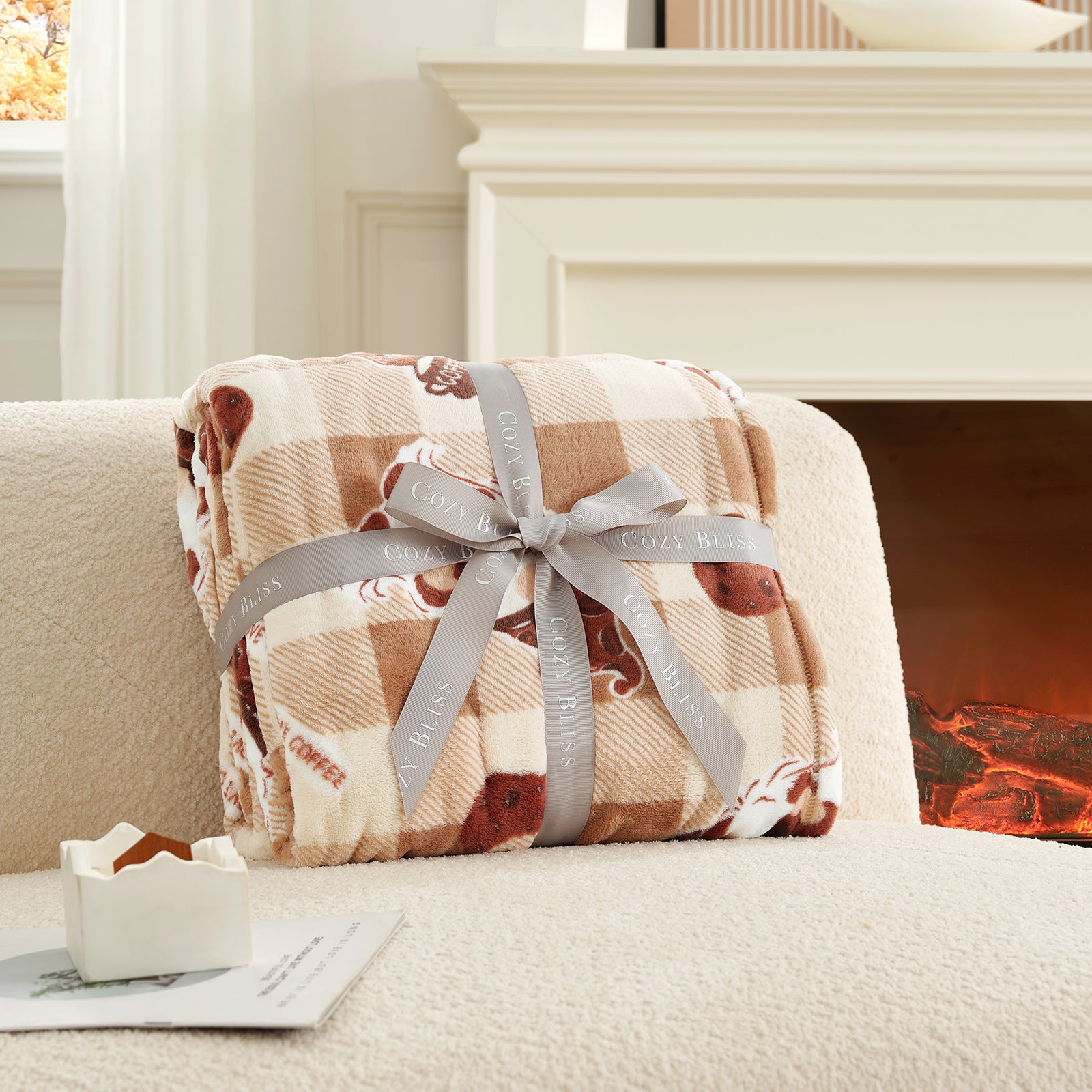 Plaid blanket with a gray ribbon on a couch in front of a fireplace #color_Coffee Gnome Brown