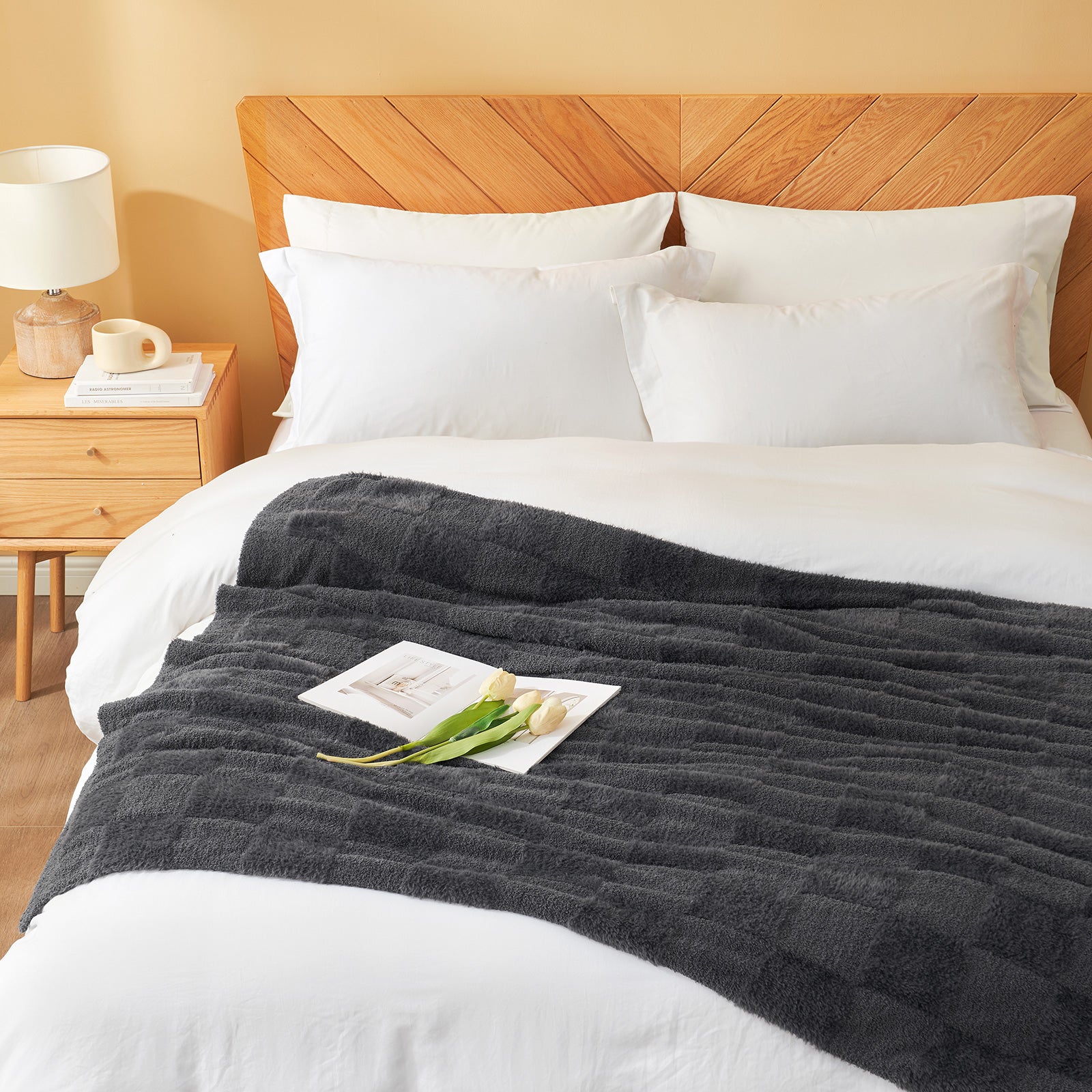 Checkered Faux Fur Feather Yarn Throw Blanket in Dark Grey styled on a bed, adding a cozy touch. #color_Dark Grey