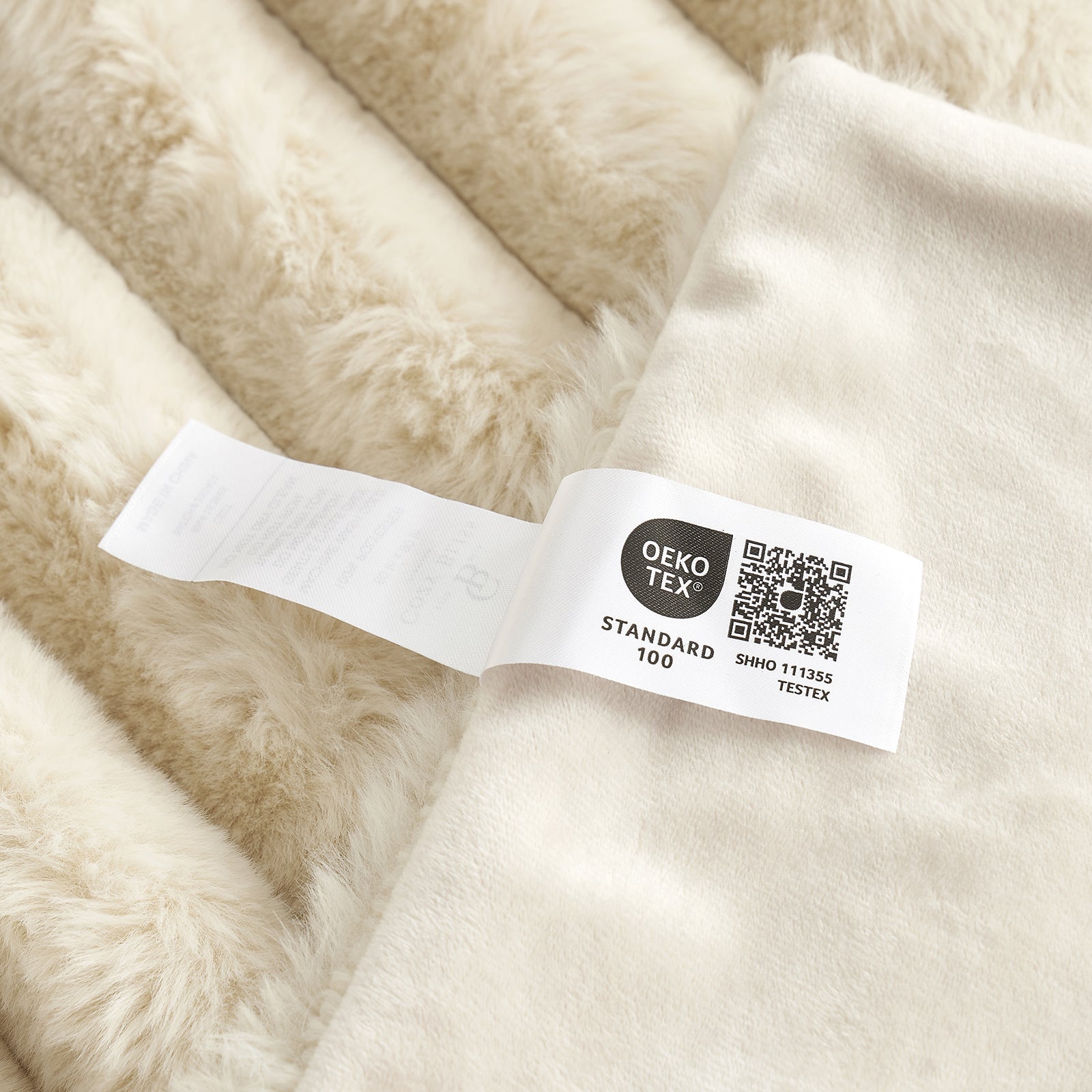 Cozy Bliss beige striped faux fur blanket with Oeko-Tex Standard 100 label, soft and cozy bedding. #color_Beige