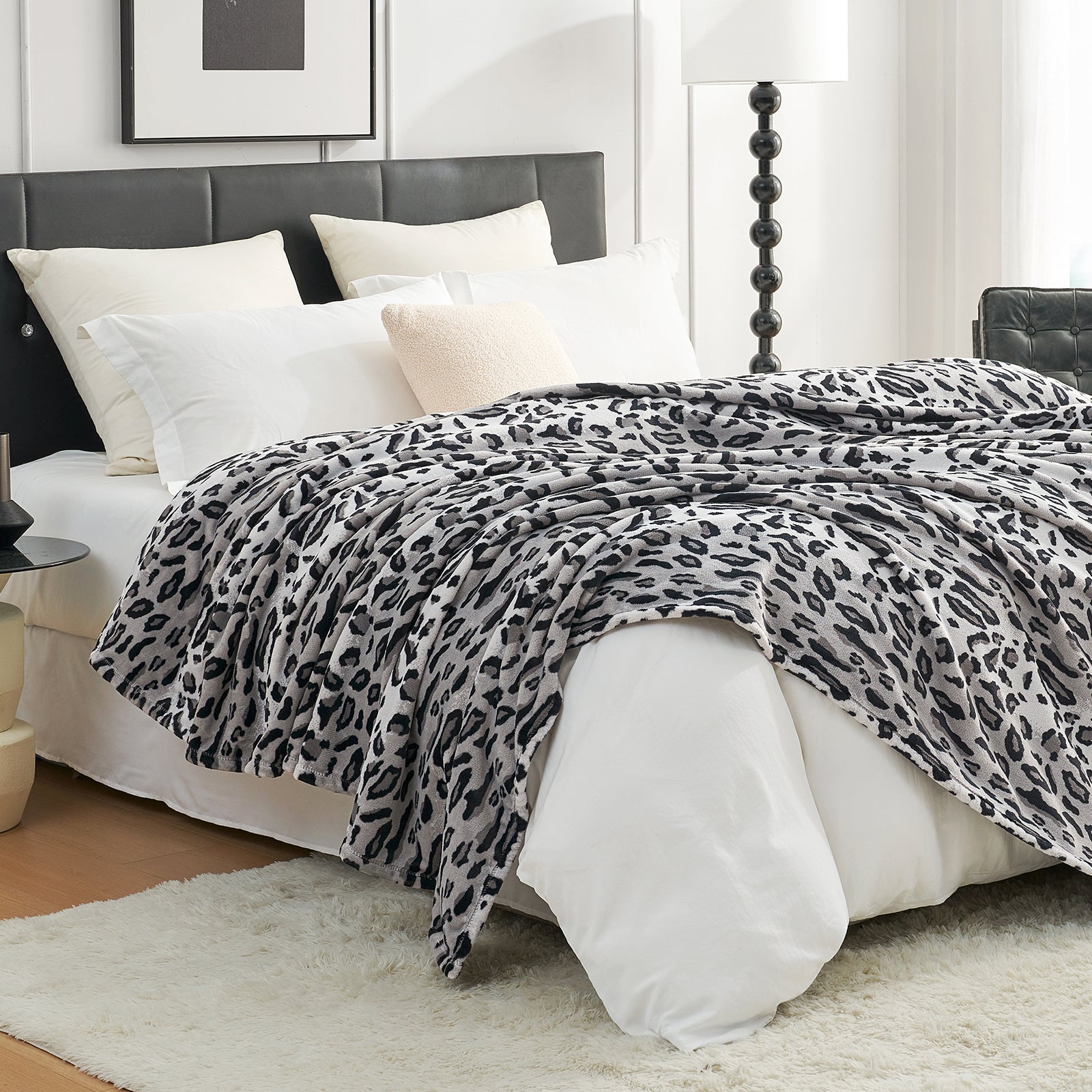 Leopard print blanket draped over a bed, cozy bedroom aesthetic. #color_Silvery Leopard