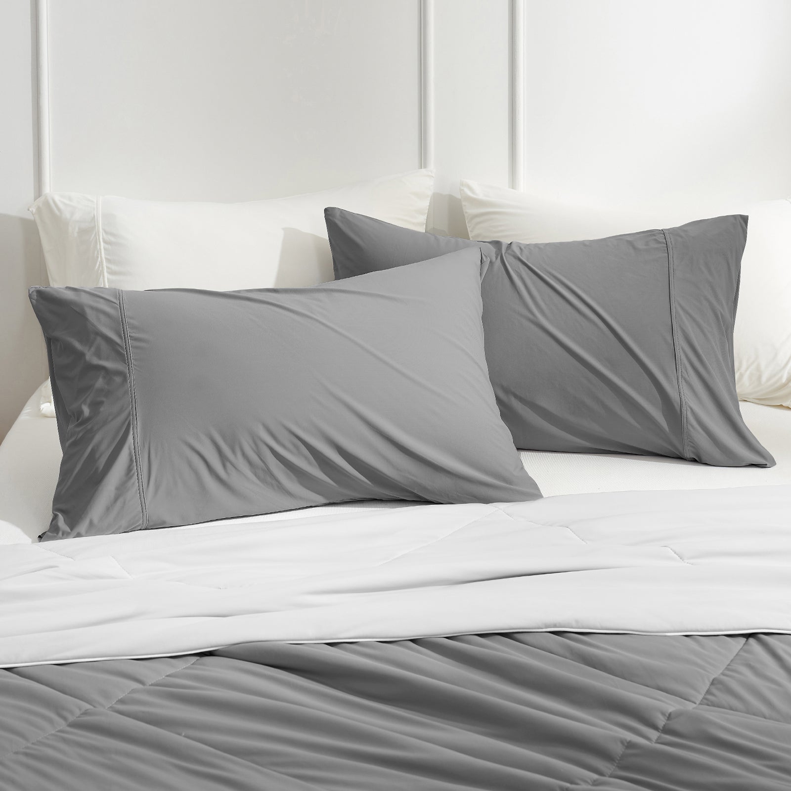 Gray cooling pillowcases on bed, Cozy bedding for comfortable sleep, breathable fabric and cozy bliss. #color_Dark Grey