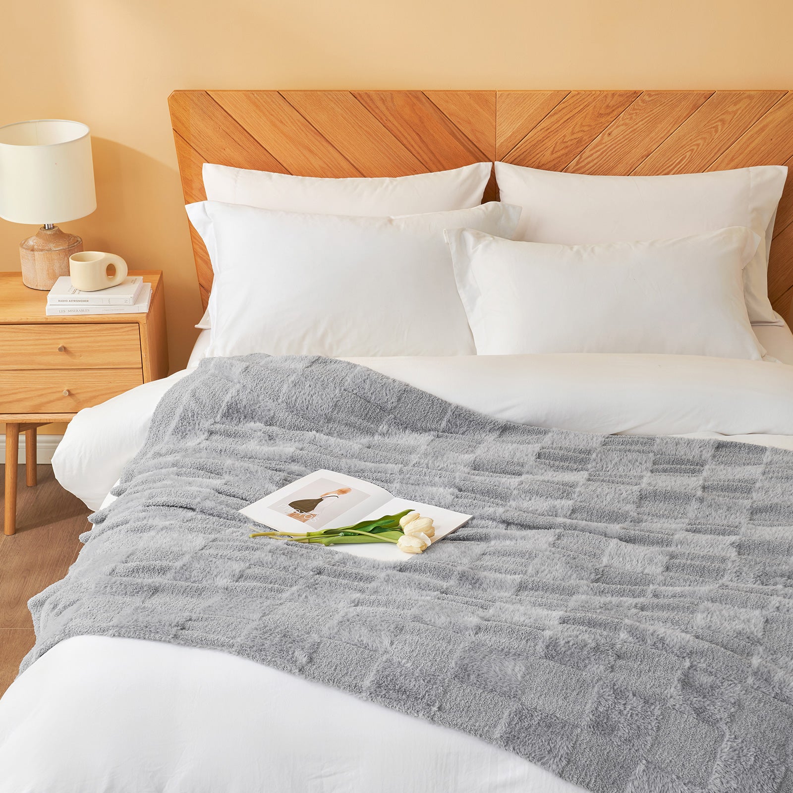 Checkered Faux Fur Feather Yarn Throw Blanket in Light Grey styled on a bed, adding a cozy touch. #Color_Light Grey