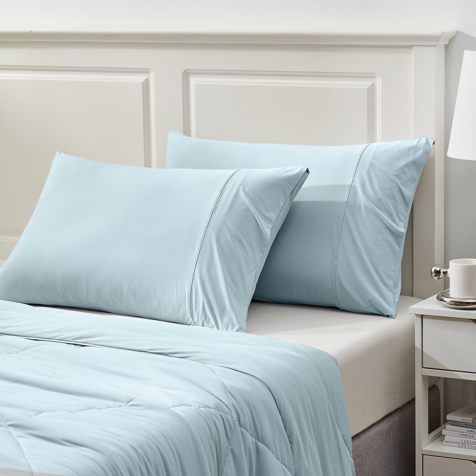 Light blue cooling pillowcases and comforter set on bed, ideal for cool and comfortable sleep; breathable fabric #color_Blue