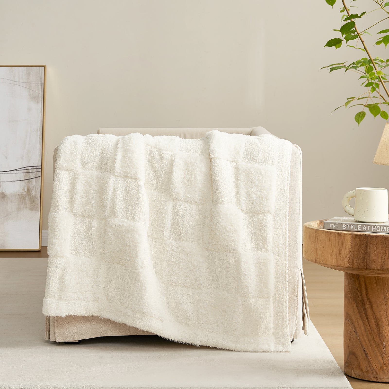 Checkered Faux Fur Feather Yarn Throw Blanket in Ivory draped over a sofa, highlighting its soft feel and subtle pattern. #color_Ivory