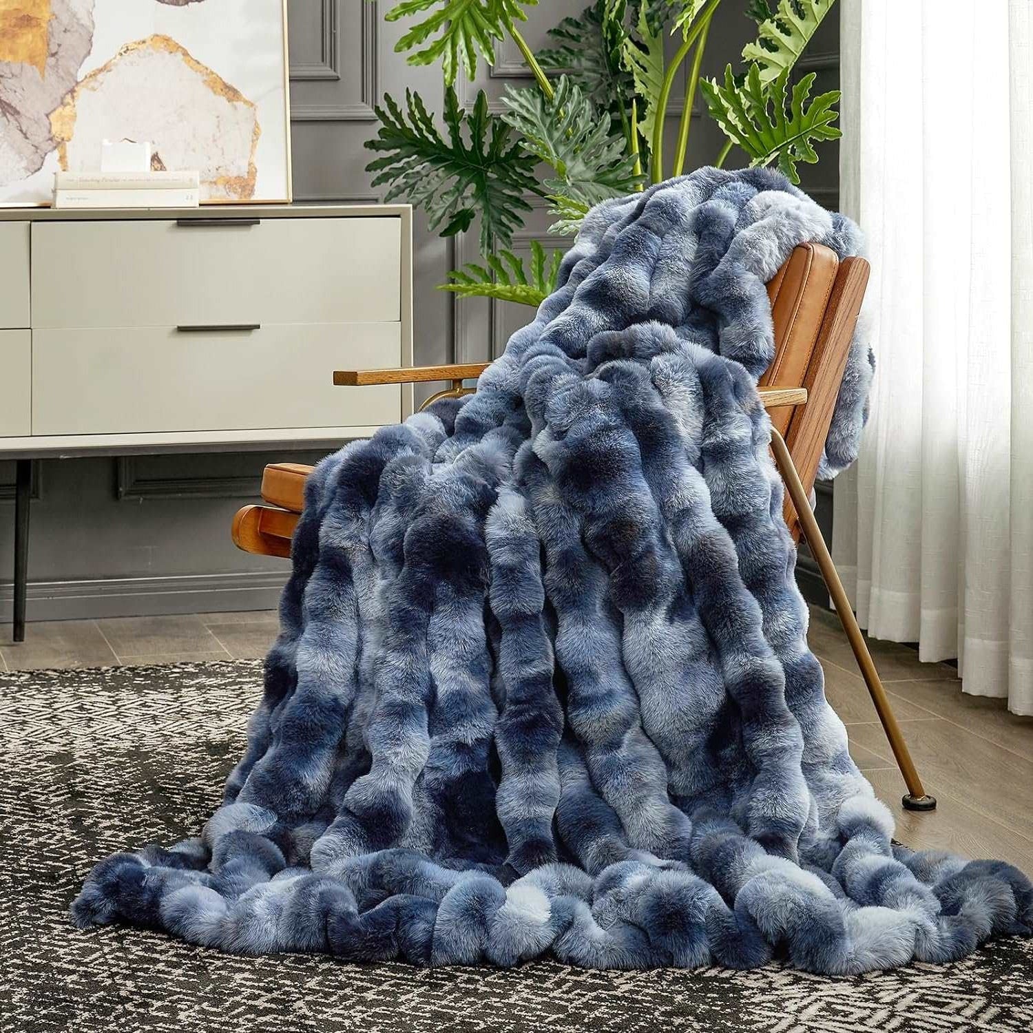 Cozy Bliss Bubble Faux Fur Throw Blanket in blue and gray tie-dye, draped on a chair for cozy comfort #color_Tie-dye Blue