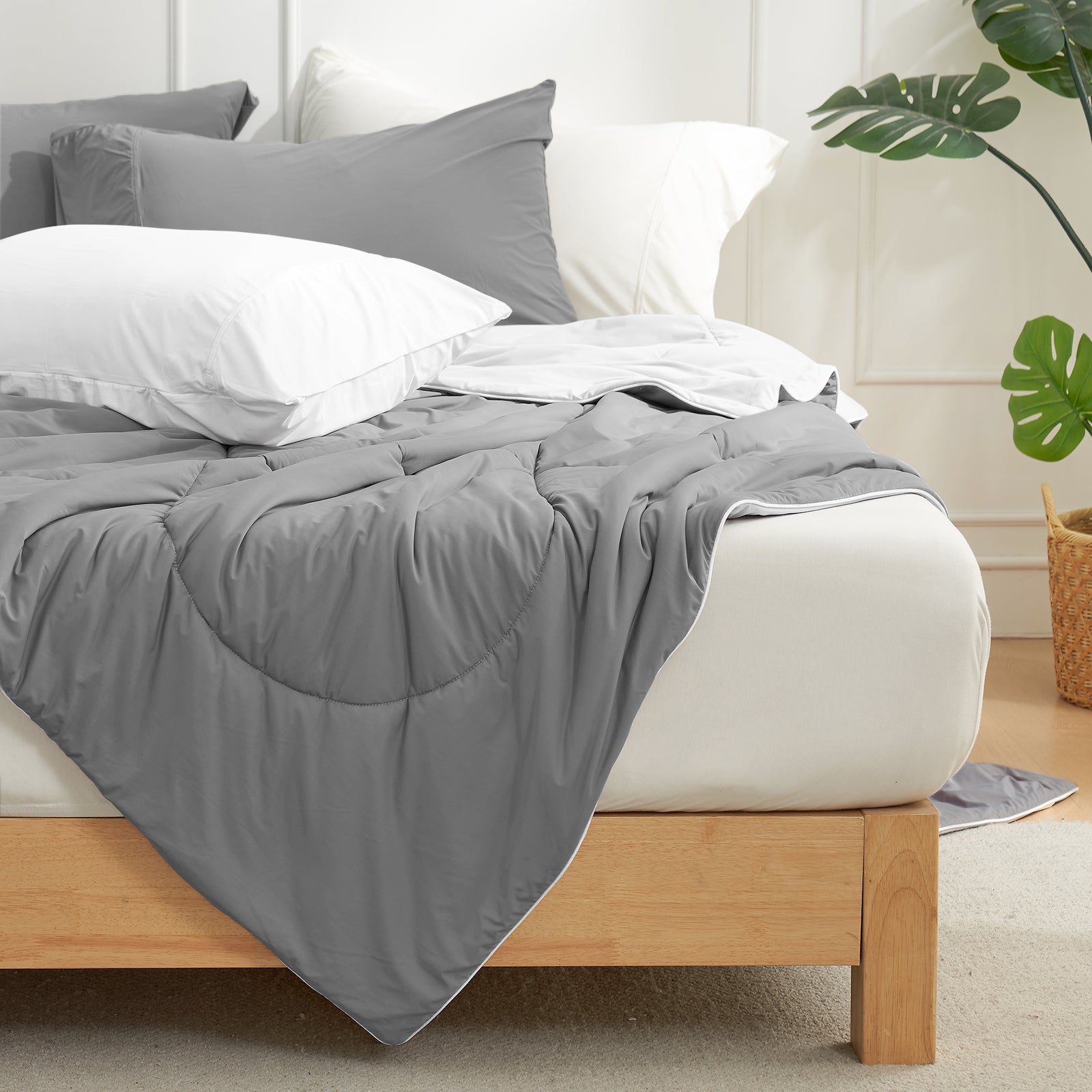 Cozy Bliss cooling comforter in gray on bed with white pillows. Breathable bedding for hot sleepers. #Color_ Dark/Light Grey