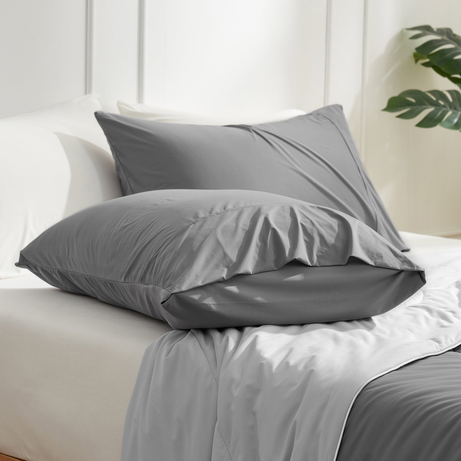 Gray cooling pillowcases on bed from Cozybliss. Breathable bedding for comfortable sleep. #color_Dark Grey