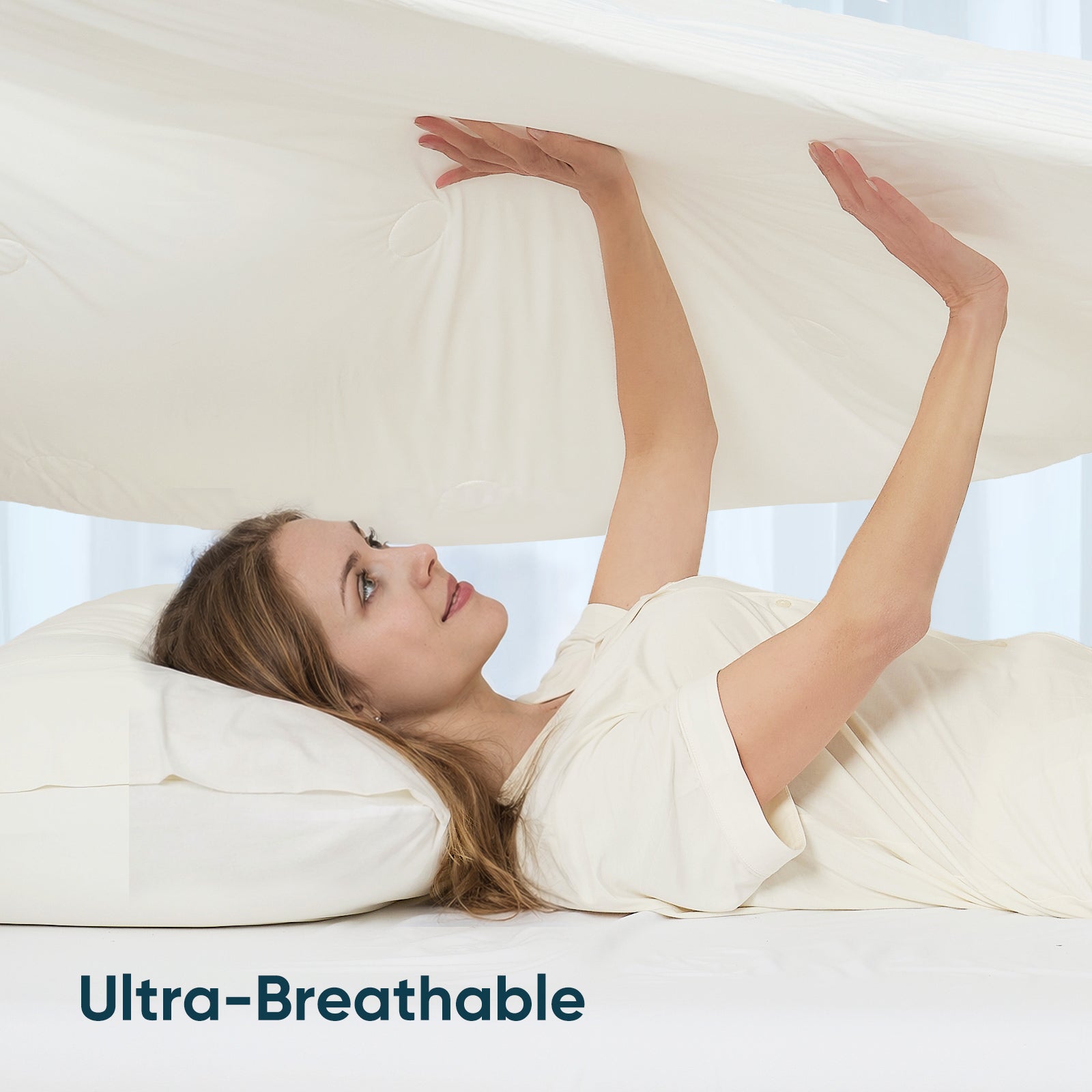 Women touching breathable cooling comforter.#color_White