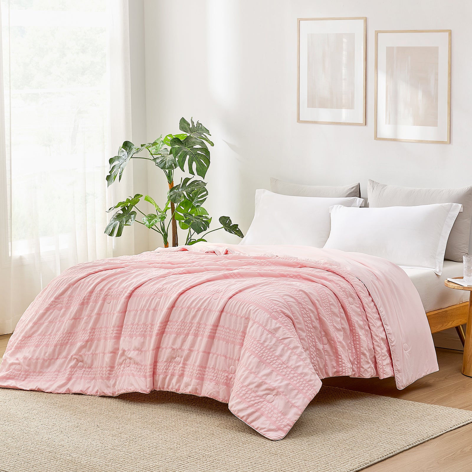 Pink seersucker cooling comforter on bed, Cozy Bliss bedding, breathable and soft. #color_Pink