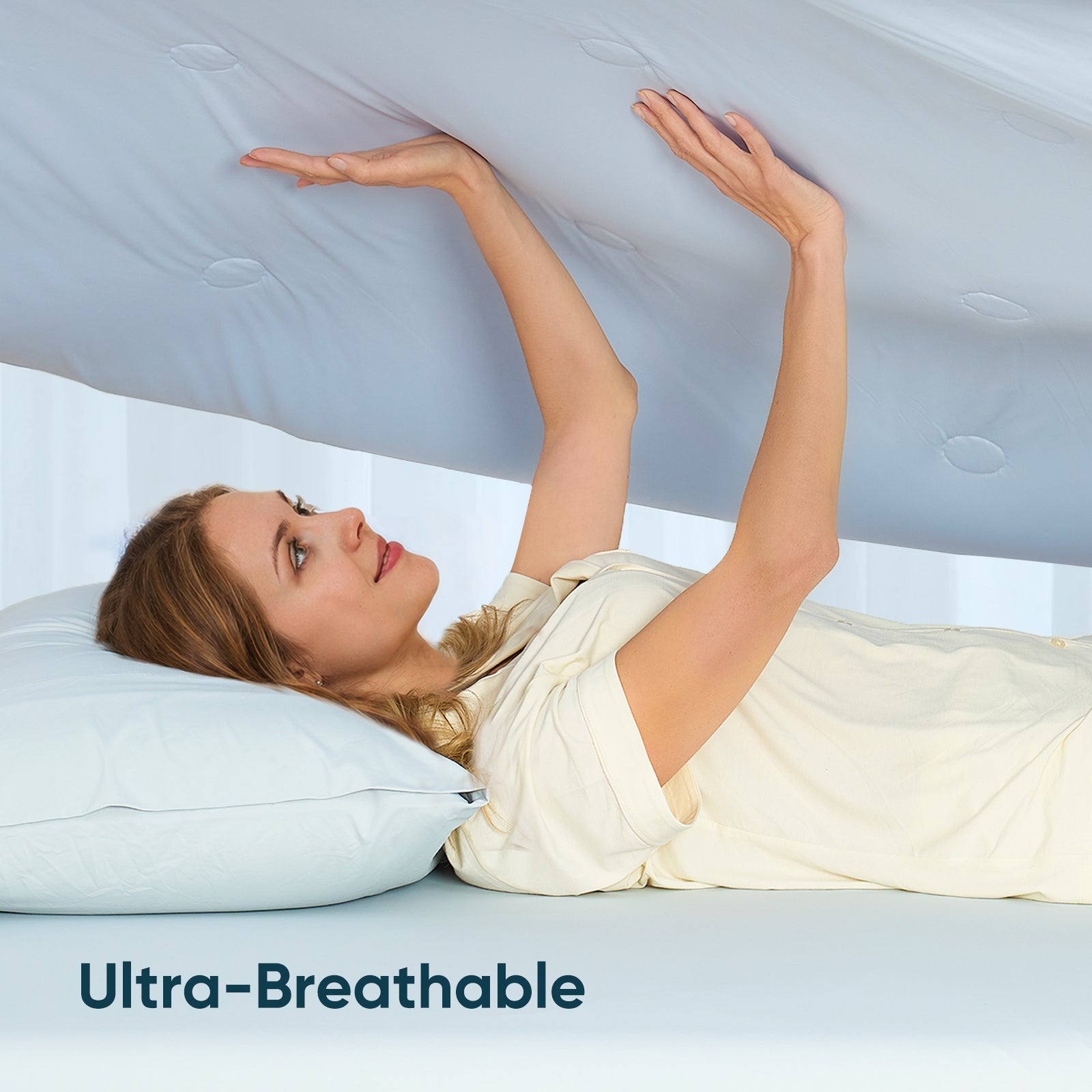 Women touching breathable cooling comforter.#color_Blue