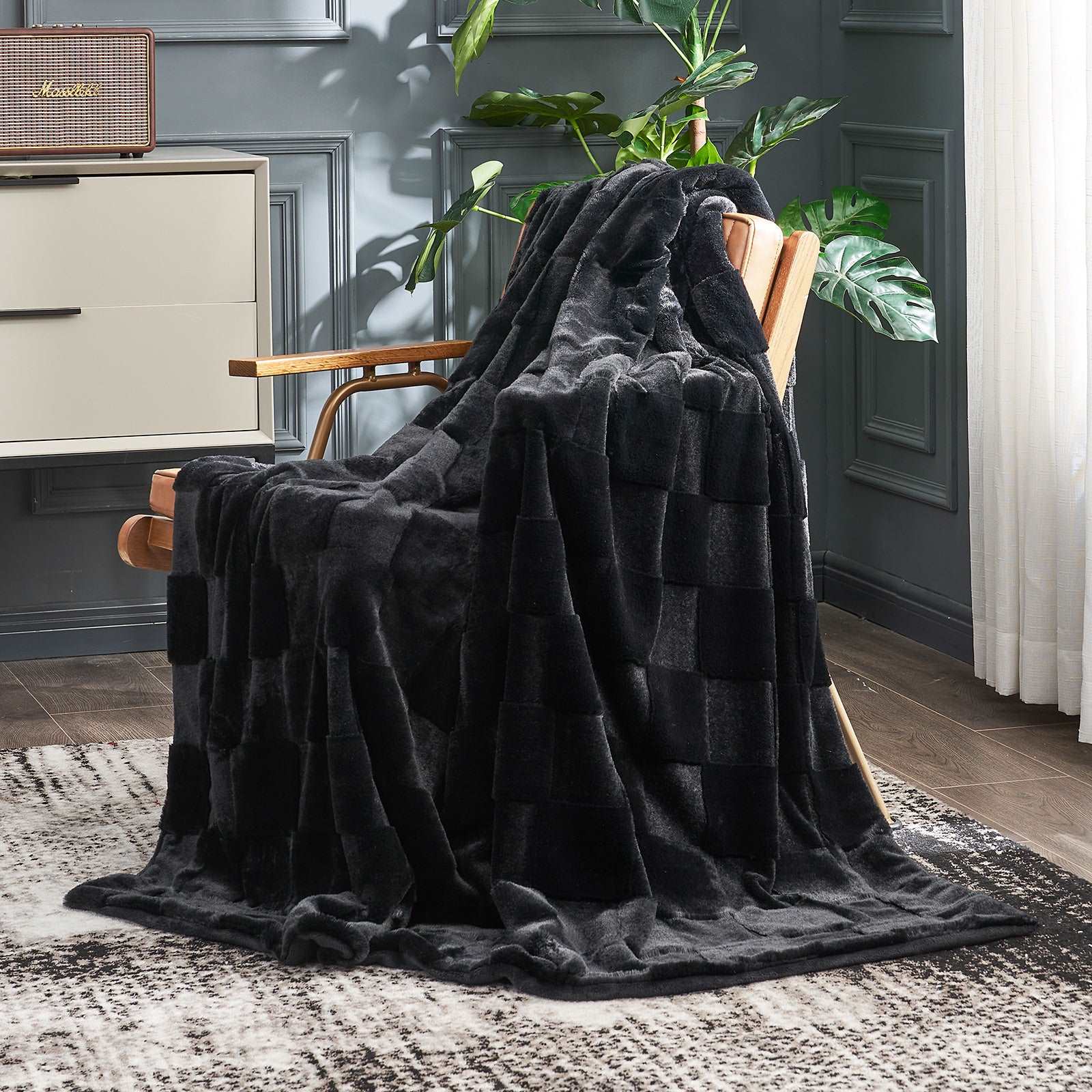 Black checkerboard faux fur blanket draped on chair, perfect for cozy bedding and modern home decor #color_Black