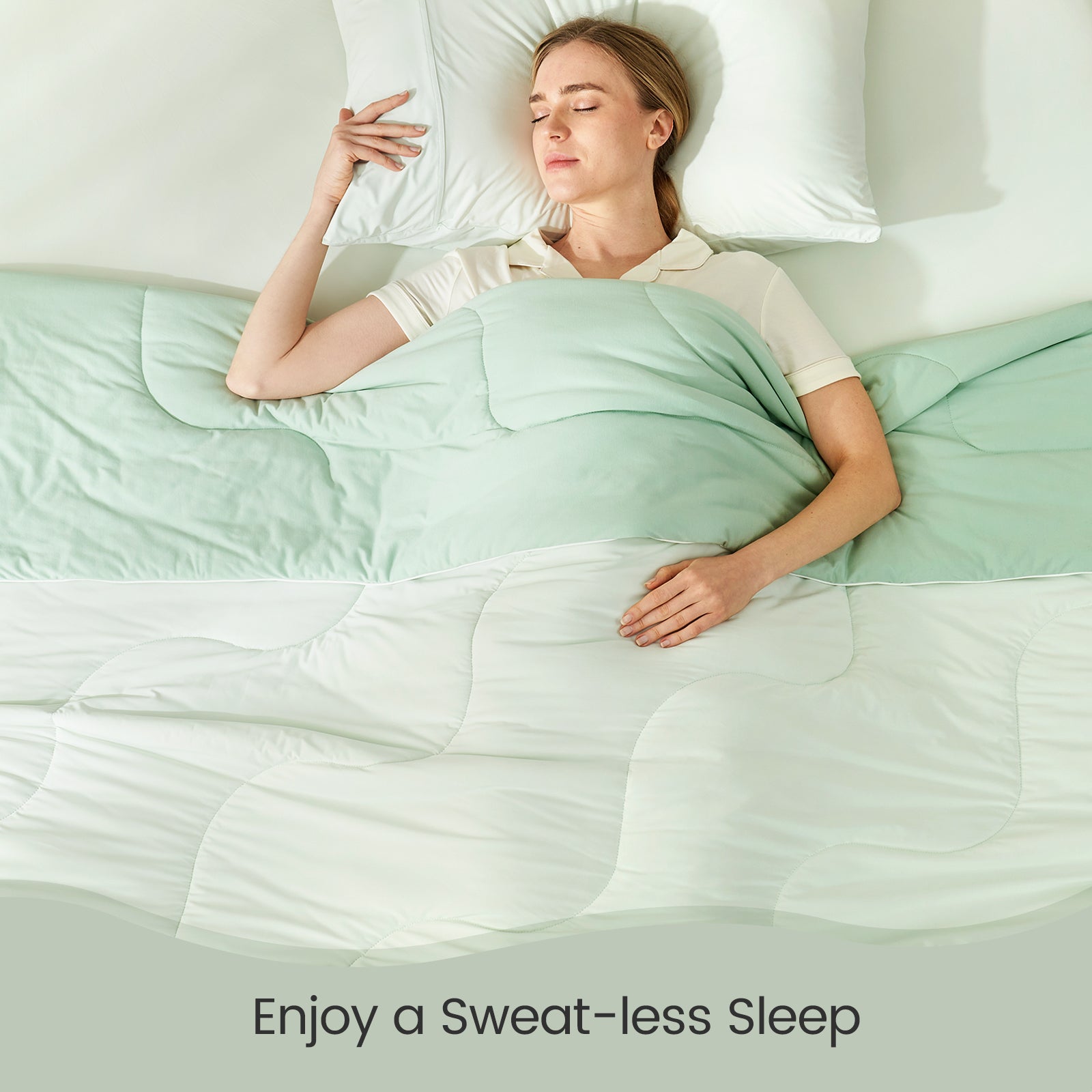 Cozy Bliss cooling comforter, woman enjoying sweat-free, breathable, and comfortable sleep. #color_Mint Green