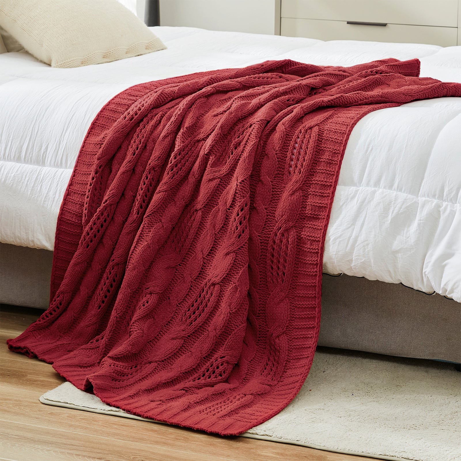 Chenille Cable Knit Throw Blanket in Red styled on a bed in a modern bedroom, adding warmth and a bold cozy look. #color_Christmas Red