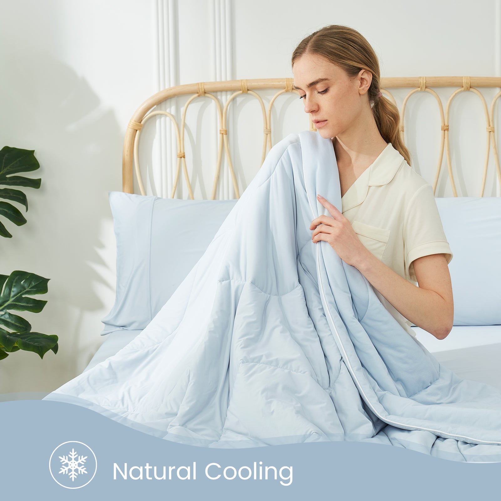 Woman with Cozy Bliss cooling comforter, natural cooling #color_Cool Blue