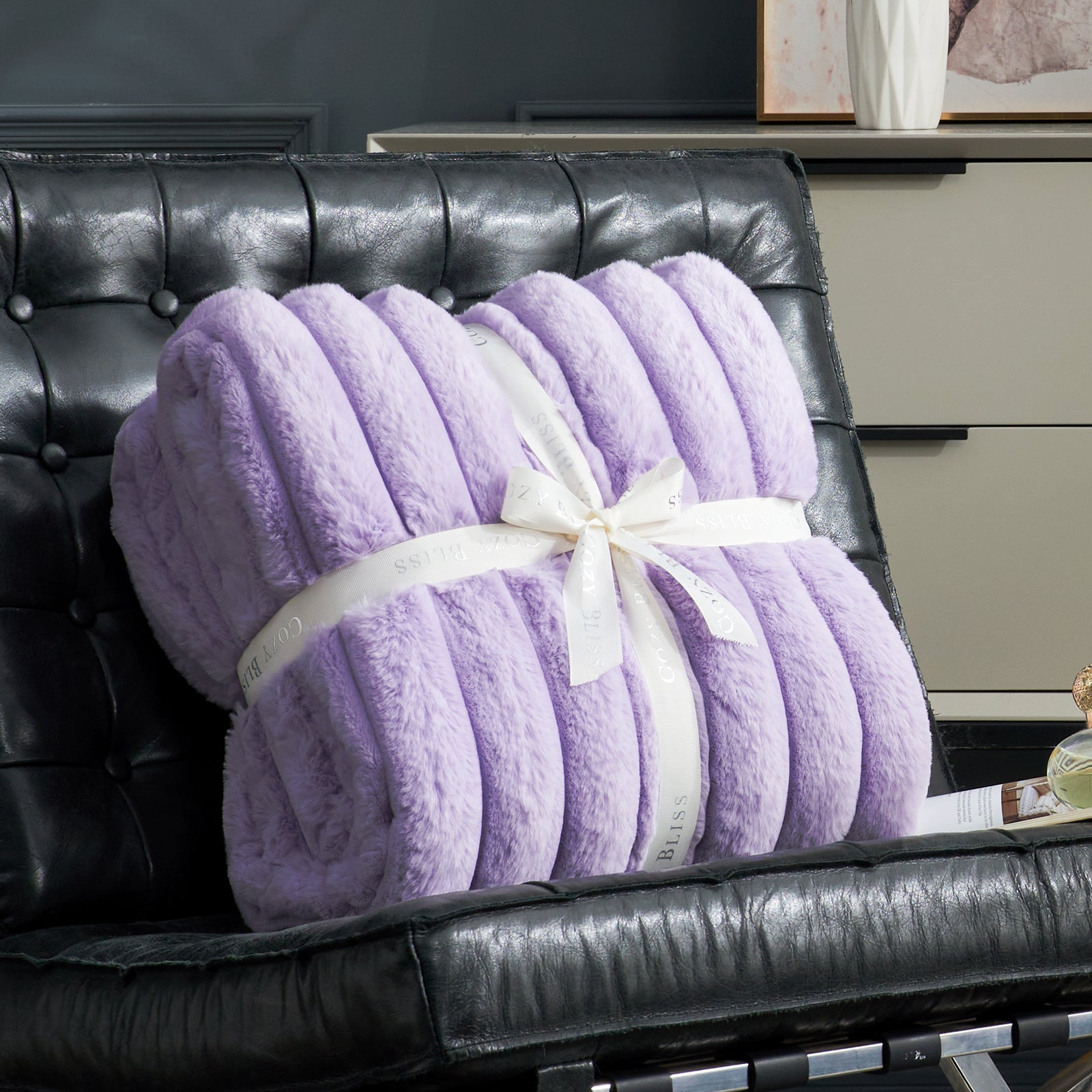 Cozy Bliss lavender faux fur blanket, striped design, tied with a ribbon, perfect cozy bedding. #color_Lavender Purple