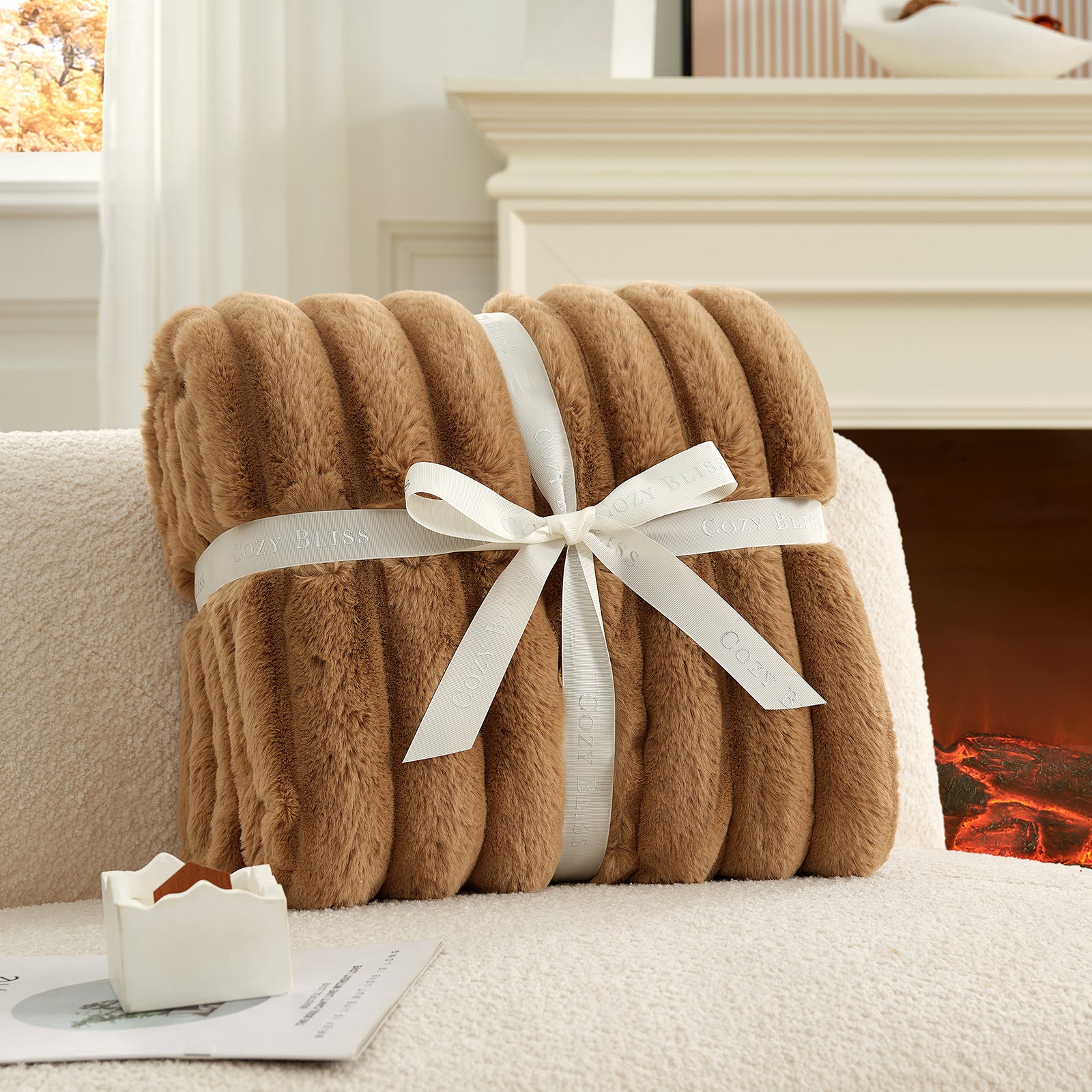 Brown blanket with a white ribbon on a couch in front of a fireplace #color_Toasty Brown