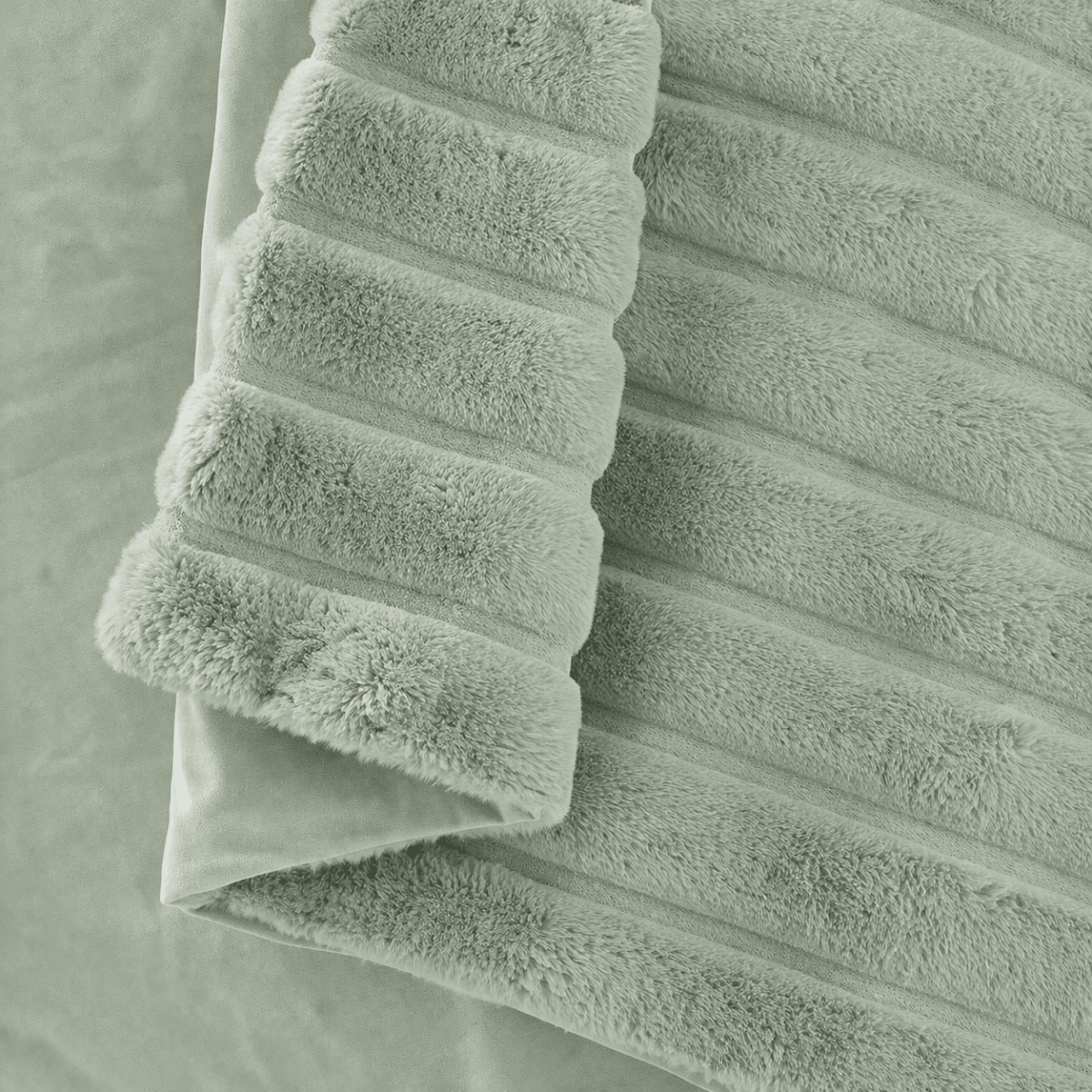 Close-up of Cozy Bliss faux fur blanket texture with ultra-soft hand feel #color_Sage Green