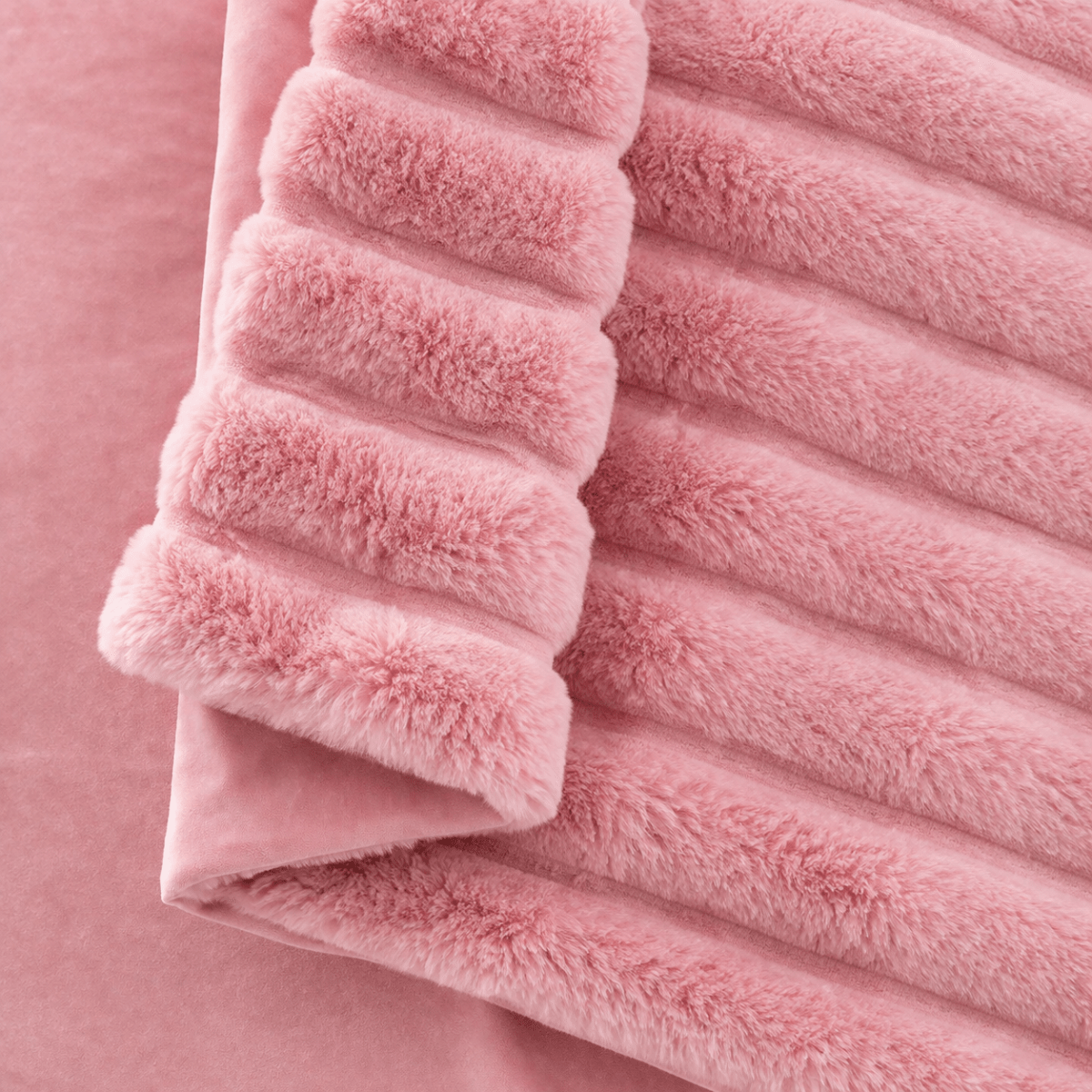 Close-up of Cozy Bliss faux fur blanket texture with ultra-soft hand feel #color_Pink