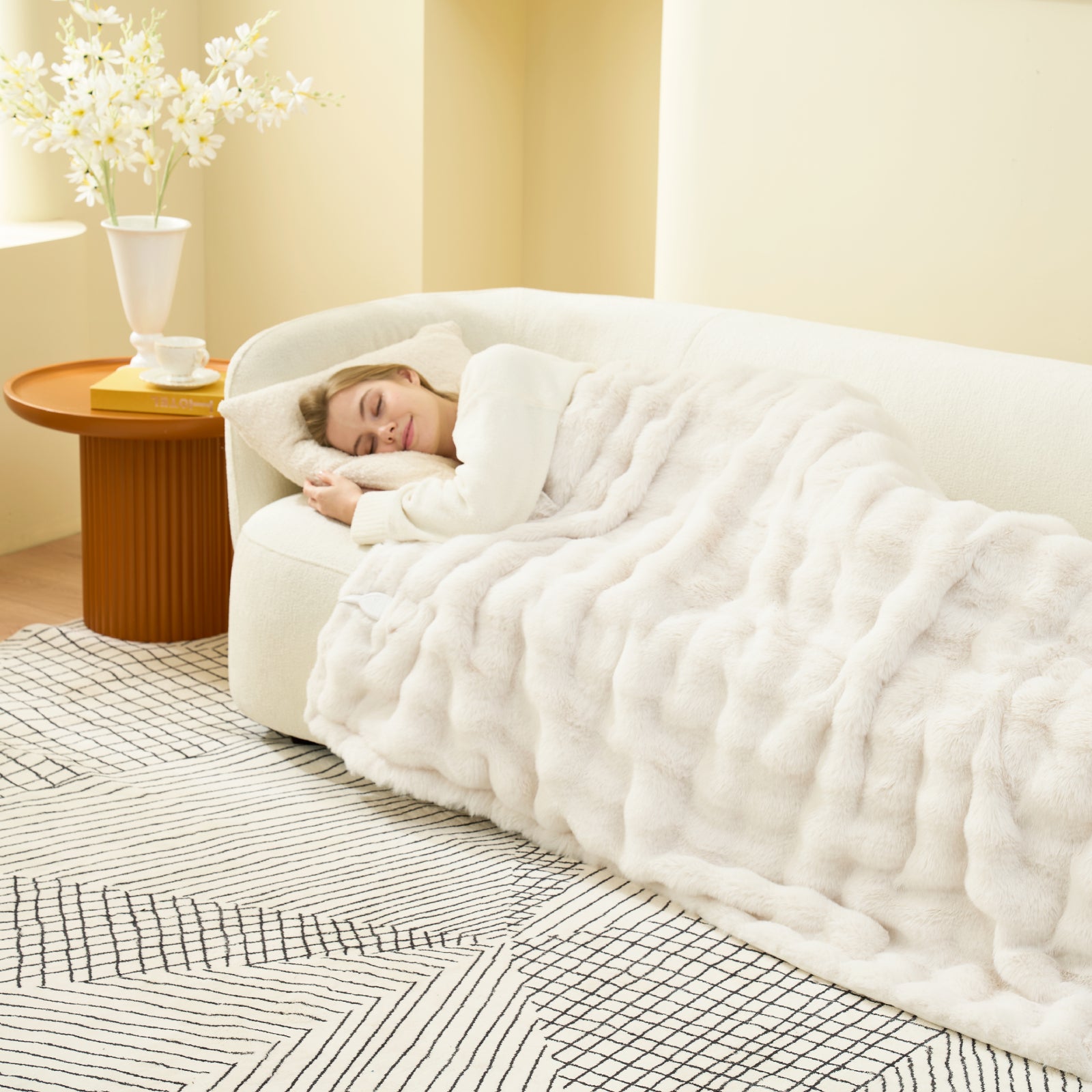 Woman sleeping on a bed with a white comforter in a cozy bedroom. #color_Cream White