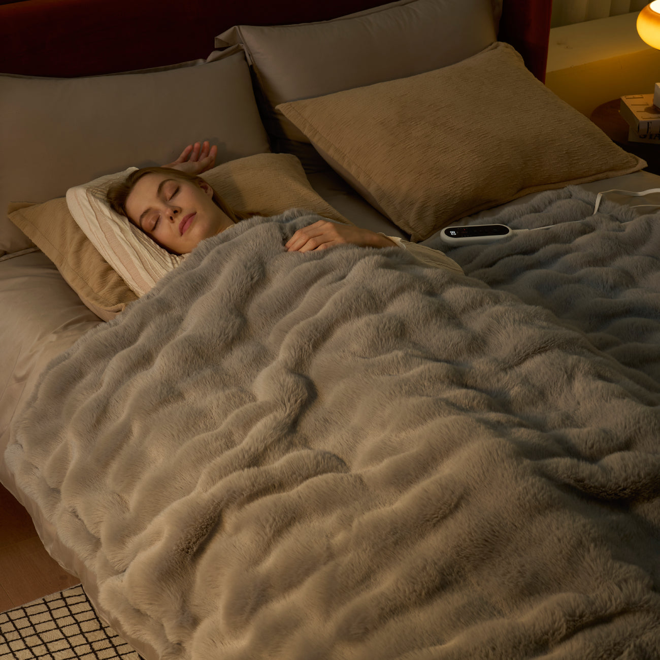 Woman sleeping under a gray blanket in a bedroom setting #color_Light Grey