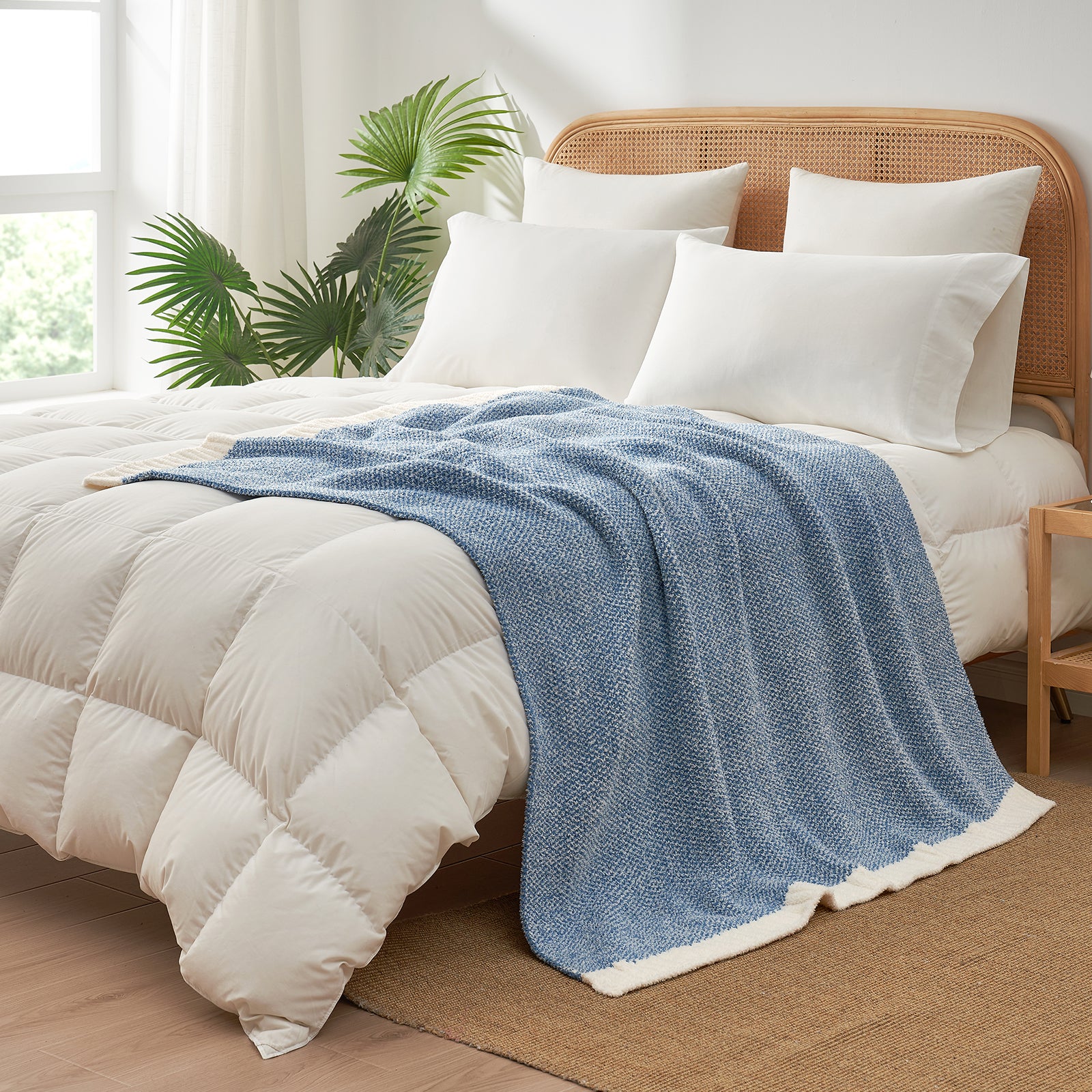 Heather Feather Yarn Throw Blanket in misty blue styled on a bed, enhancing bedroom decor with a soft, elegant and cozy layered look. #Color_Misty Blue