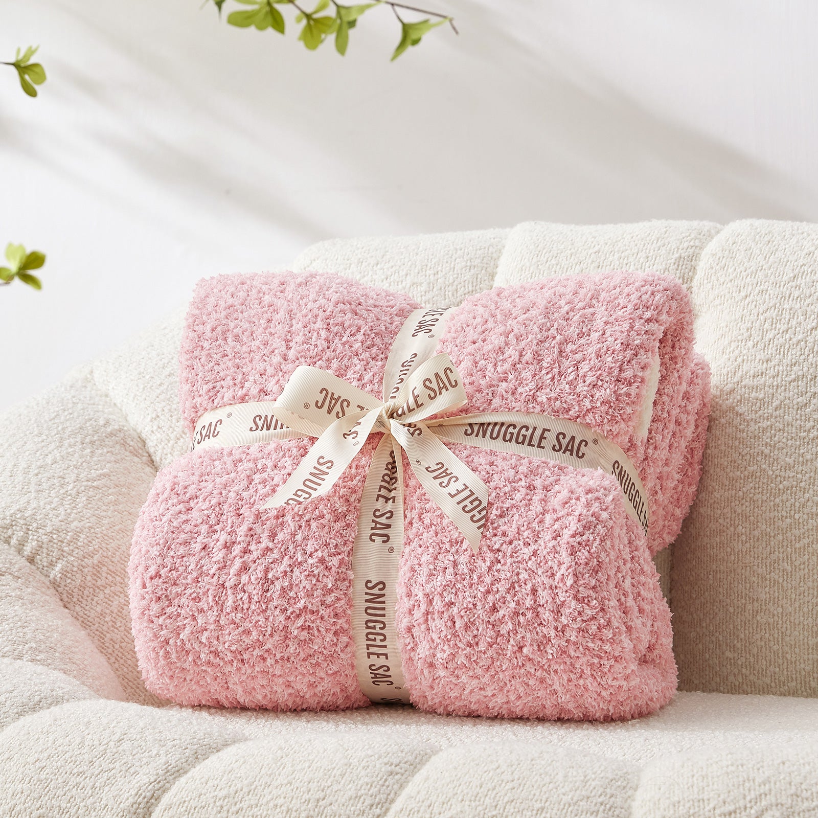 Heather Feather Yarn Throw Blanket in pink neatly folded with ribbon, a perfect gift idea for holidays, housewarming or special occasions. #Color_Pink