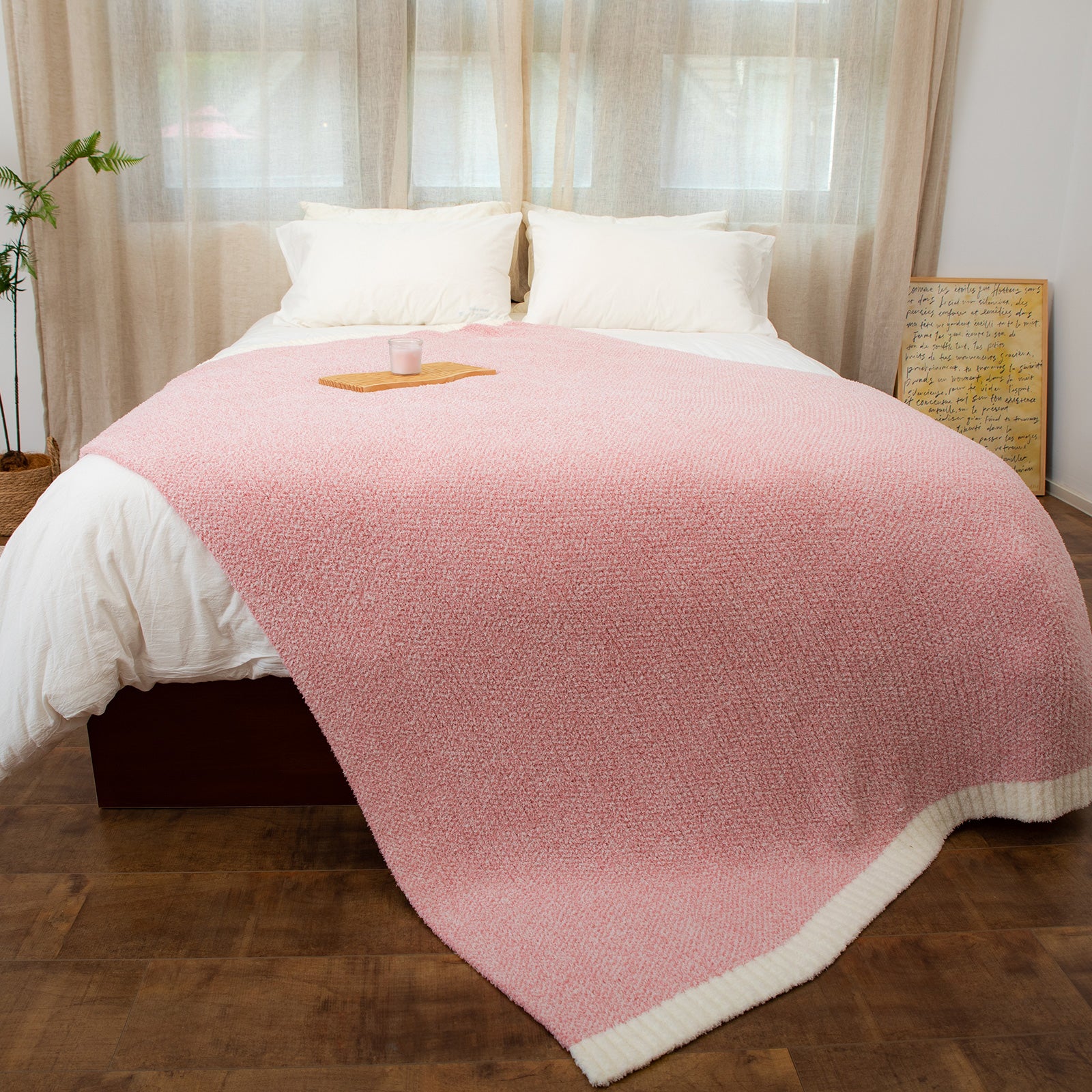 Heather Feather Yarn Throw Blanket in pink styled on a bed, enhancing bedroom decor with a soft, elegant and cozy layered look. #Color_Pink