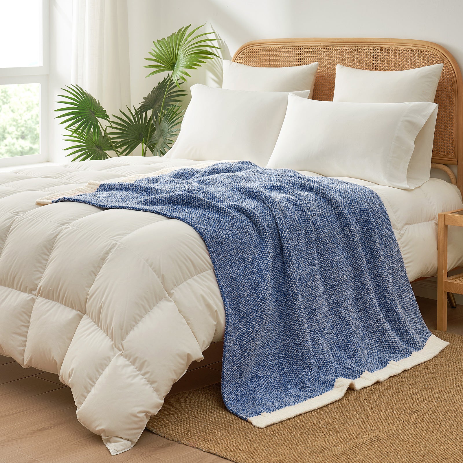 Heather Feather Yarn Throw Blanket in dark blue styled on a bed, enhancing bedroom decor with a soft, elegant and cozy layered look. #Color_Dark Blue