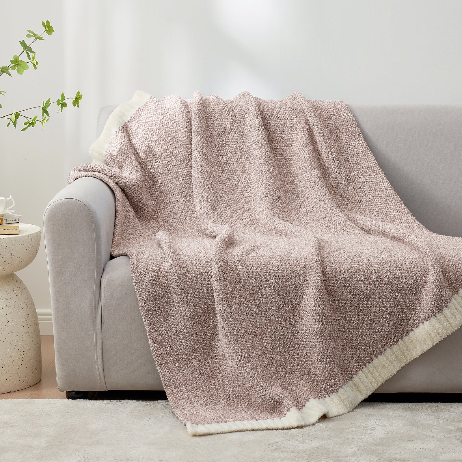 Heather Feather Yarn Throw Blanket in Brown draped over a sofa, adding warmth and a cozy feel. #color_Light Brown