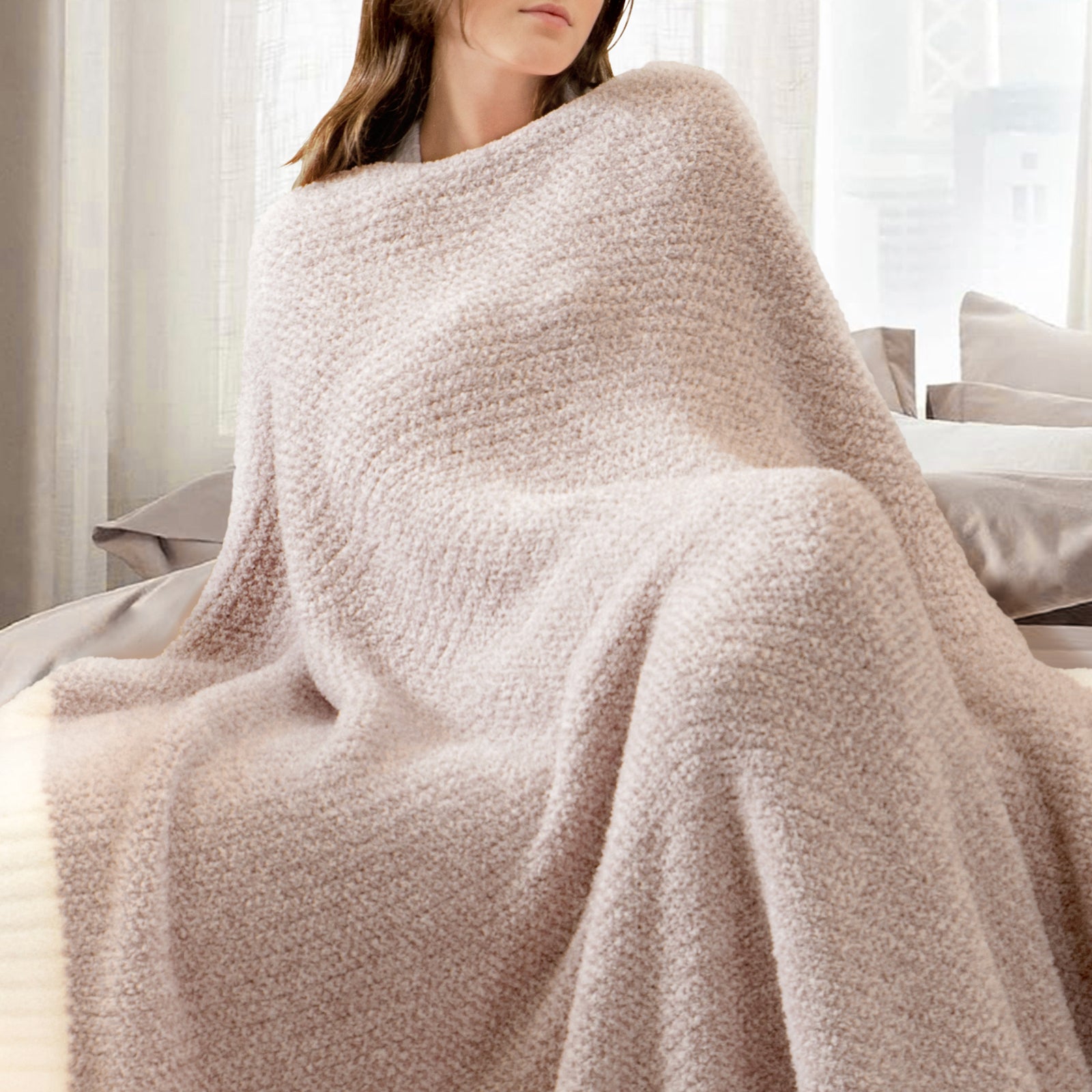 Woman wrapped in a Heather Feather Yarn Throw Blanket in brown, relaxing comfortably. #Color_Light Brown