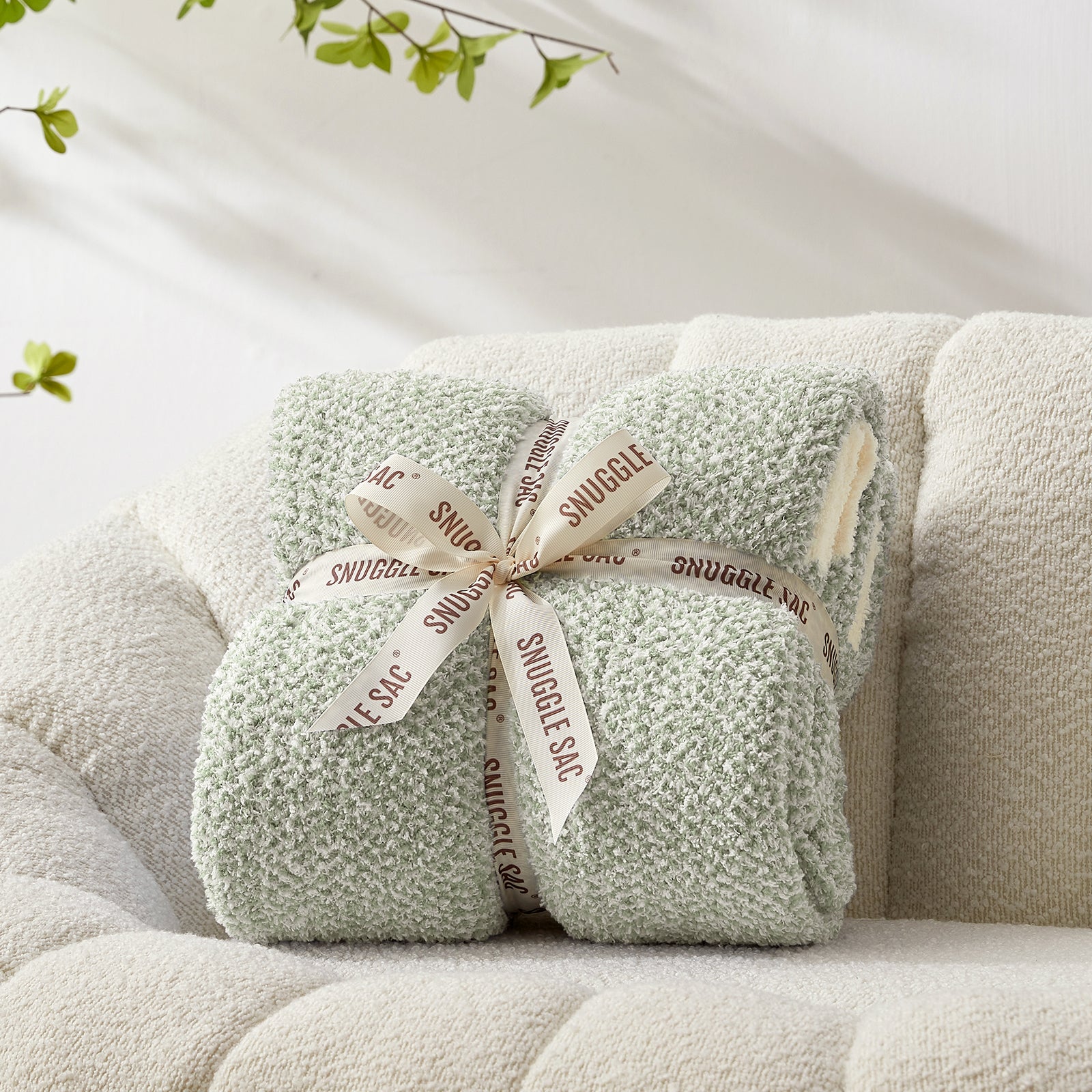 Heather Feather Yarn Throw Blanket in sage green neatly folded with ribbon, a perfect gift idea for holidays, housewarming or special occasions. #Color_Sage Green
