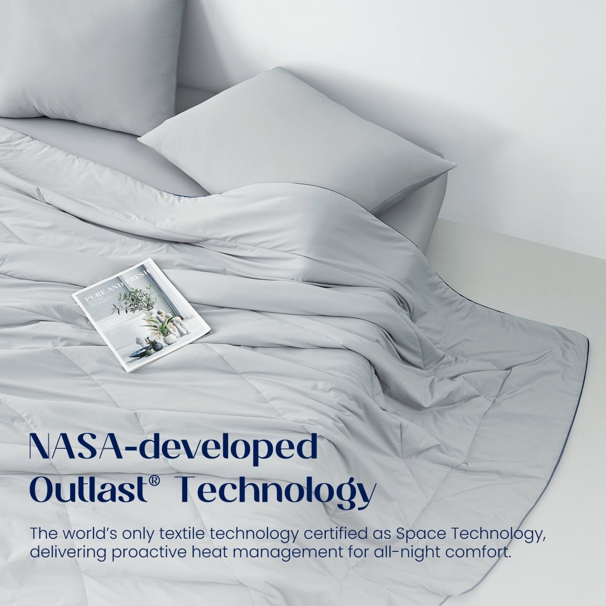 Grey bedding with a pillow and magazine on a bed, featuring NASA-developed Outlast Technology text.#color_Light Grey