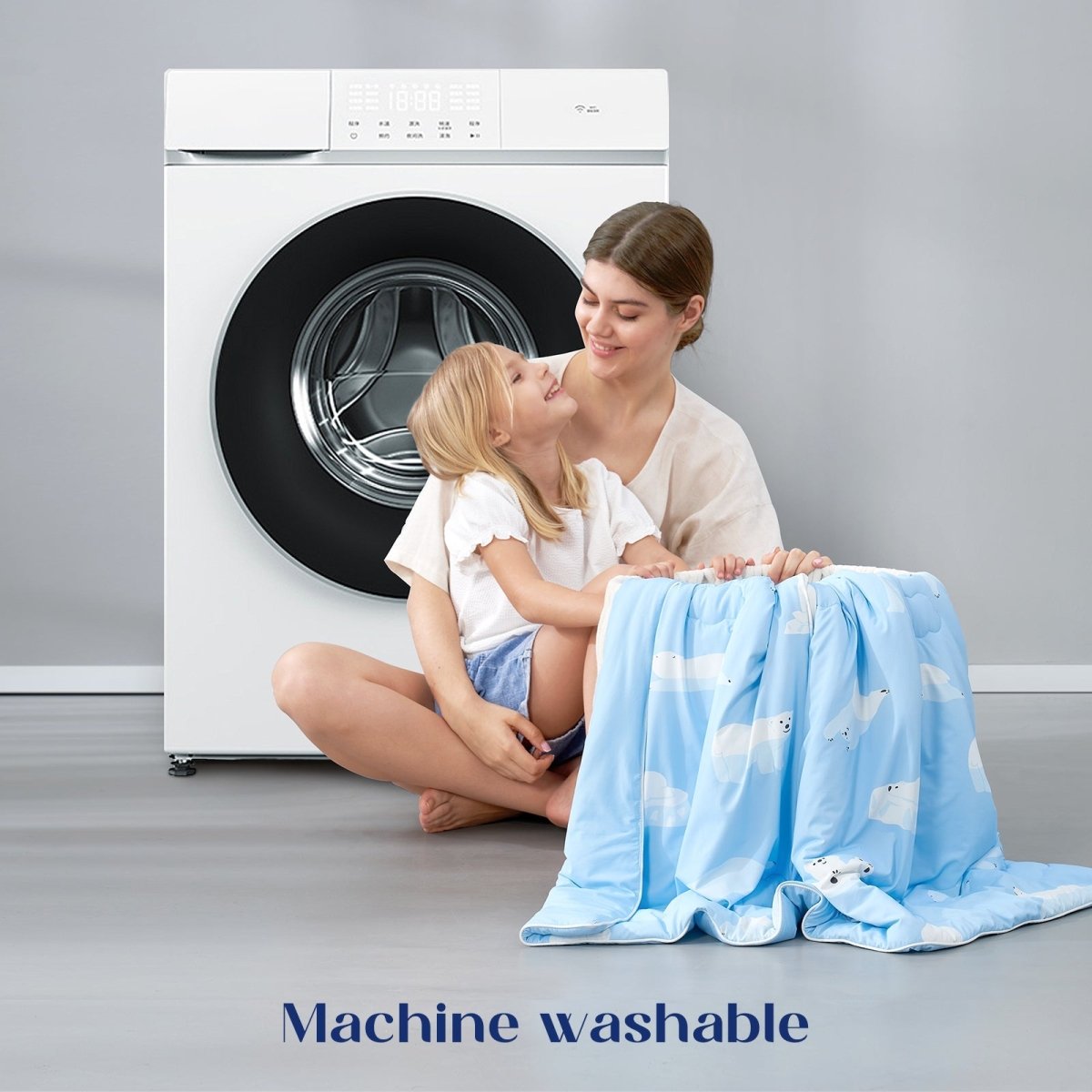 Mom and child with a machine washable blue comforter in front of a washing machine.#color_Polar Bear