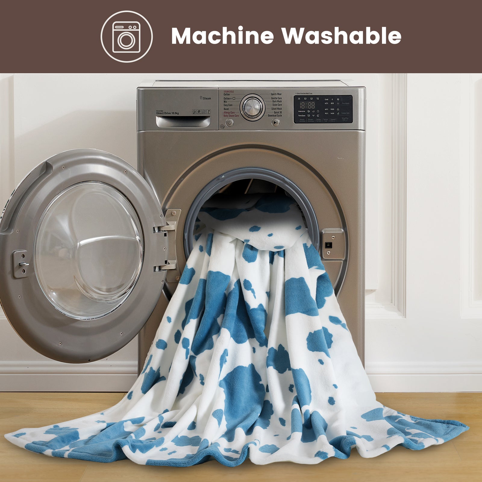 Blue and white patterned blanket emerging from a washing machine with 'Machine Washable' text above. #color_Blue