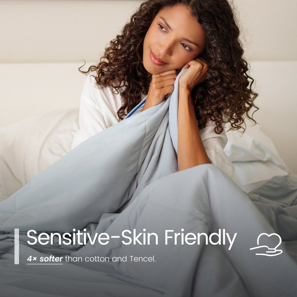 Woman wrapped in a blanket with 'Sensitive-Skin Friendly' text overlay#color_Light Grey