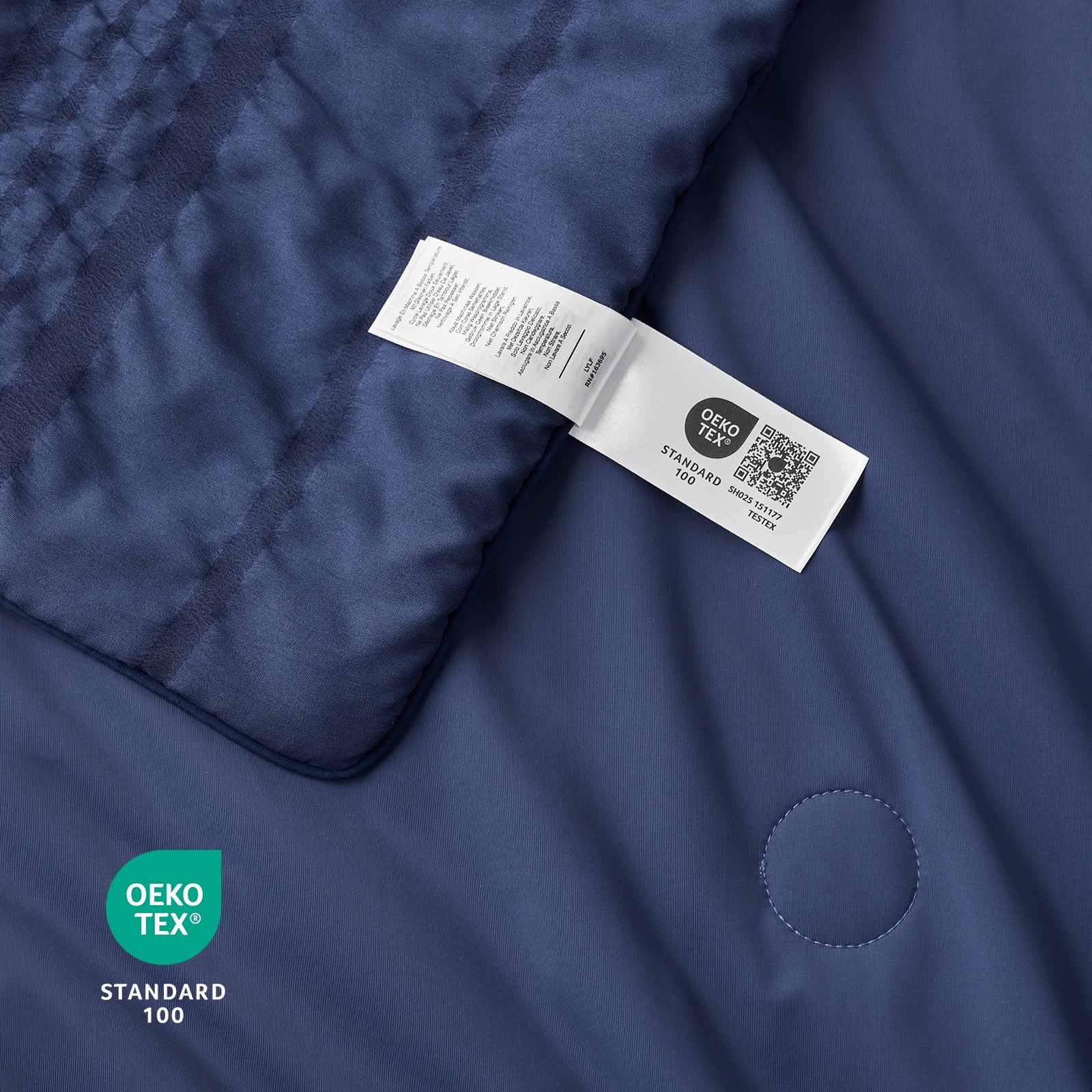 Close up of navy blue seersucker cooling fabric with OEKO-TEX Standard 100 certification.#color_Navy Blue