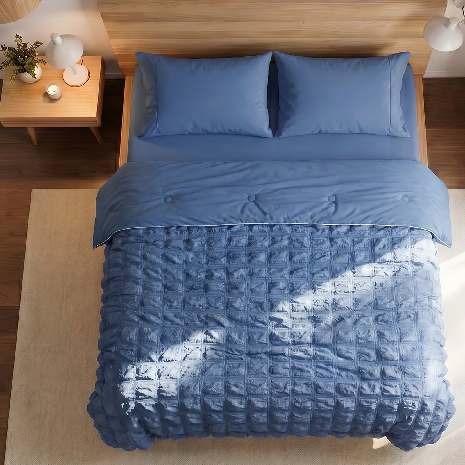 Cozy Bliss white seersucker plaid cooling comforter neatly laid out on a bed, highlighting the textured fabric design for summer.#color_ Dark Blue
