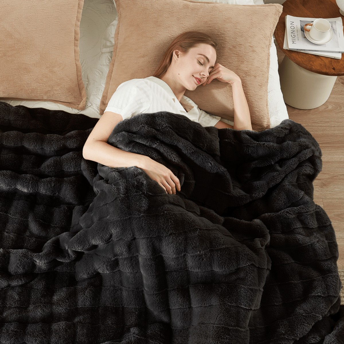 Woman relaxing on bed with soft cross-striped faux fur throw blanket. #Color_Black