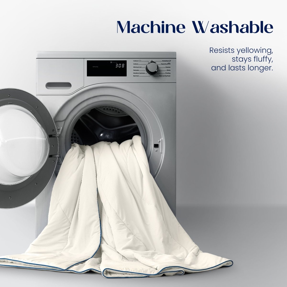 White comforter being put into a washing machine with text about machine washability.#color_Ivory