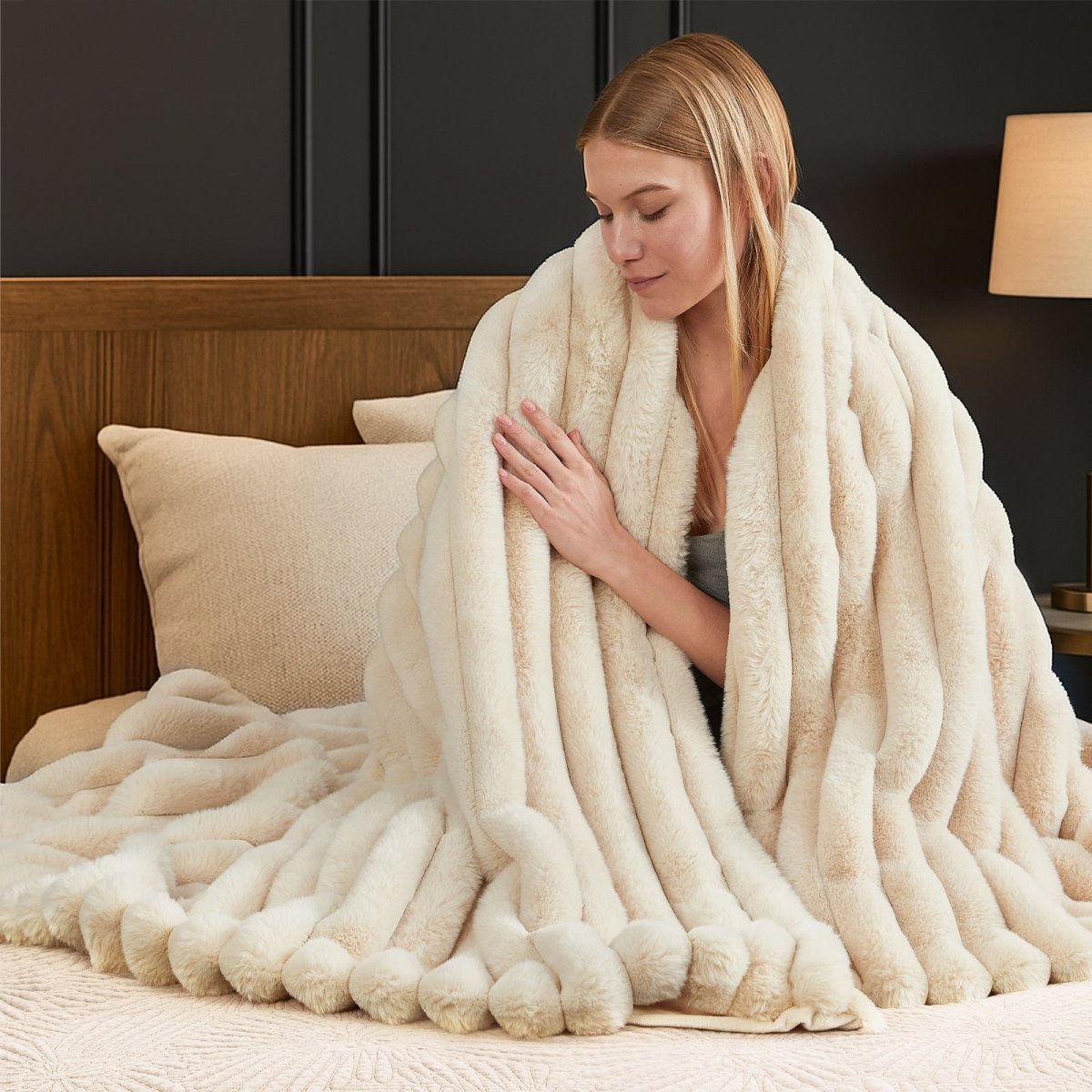 Woman wrapped in a plush white blanket on a bed. #color_Beige