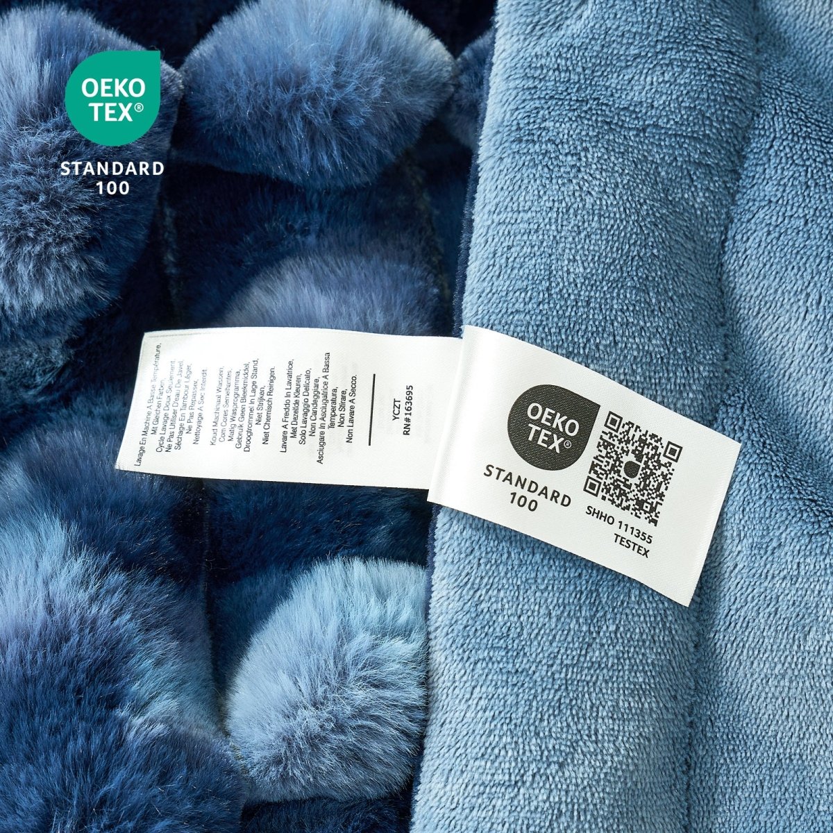 Close-up of a blue textured fabric with an OEKO-TEX label. #color_Tie-dye Blue