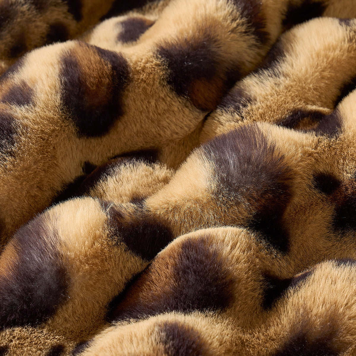 Close-up of a faux fur brown leopard blanket fabric. #Color_Brown Leopard