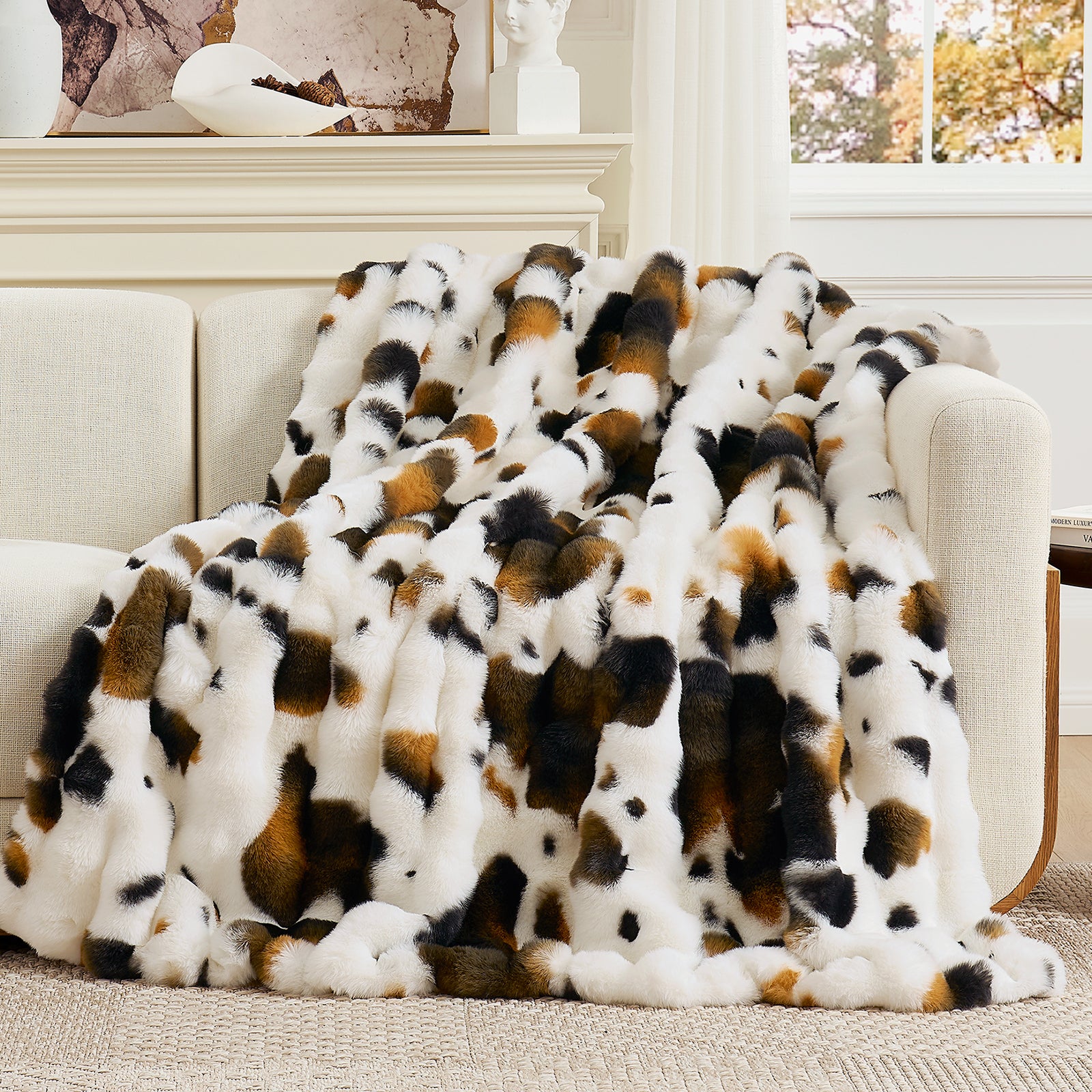 Patterned blanket draped over a sofa in a living room setting #Color_Cow