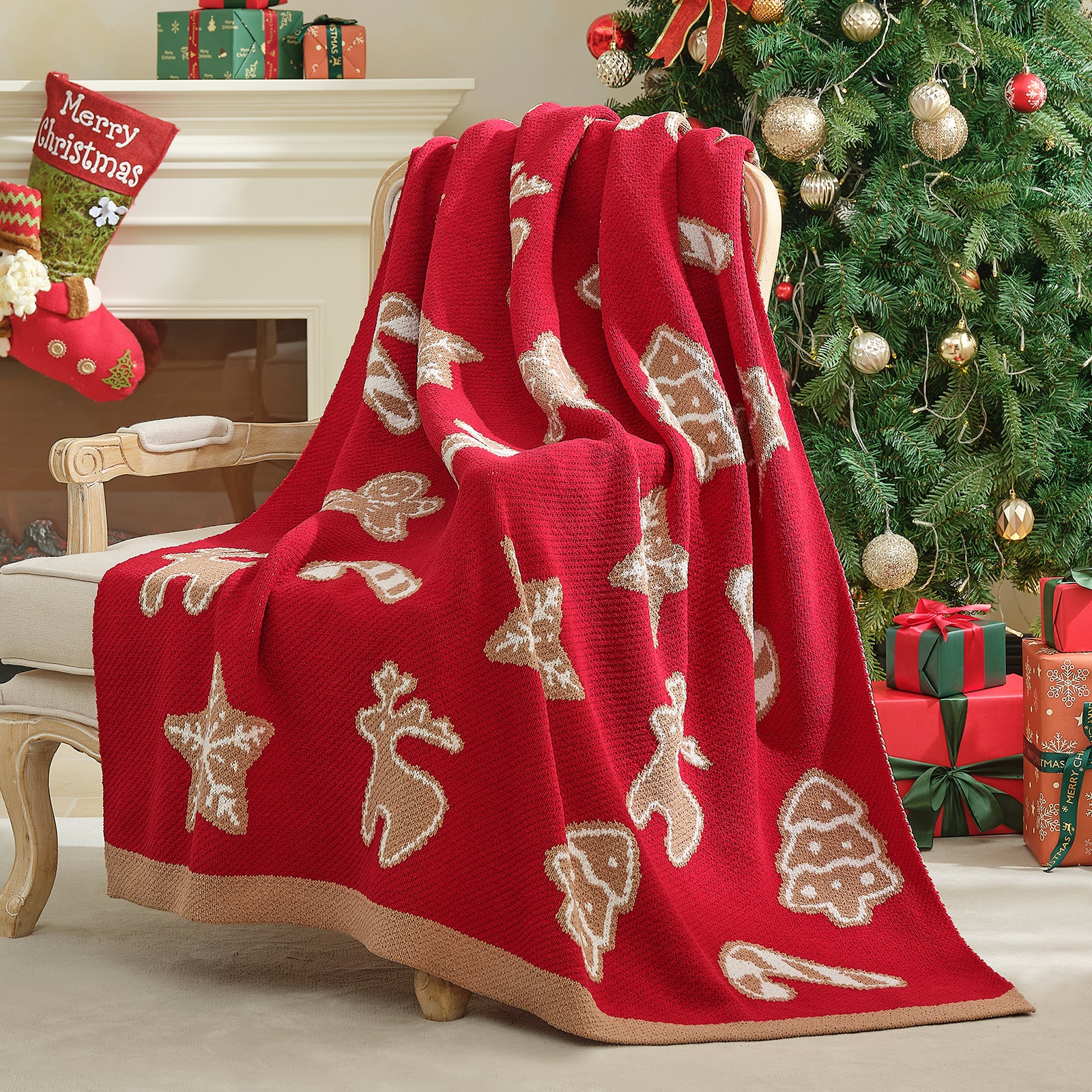 Red Christmas-themed blanket draped over a chair with a decorated tree and presents in the background. #color_Gingerbread Cookie