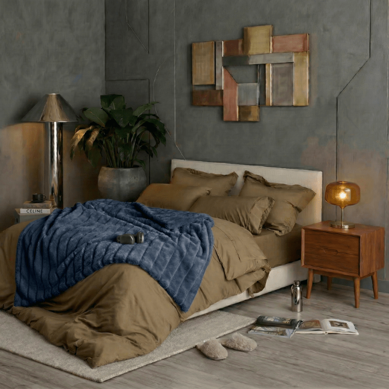 Cozy Bliss sheared faux fur throw blanket layered across the bed in a full room display #color_Navy Blue