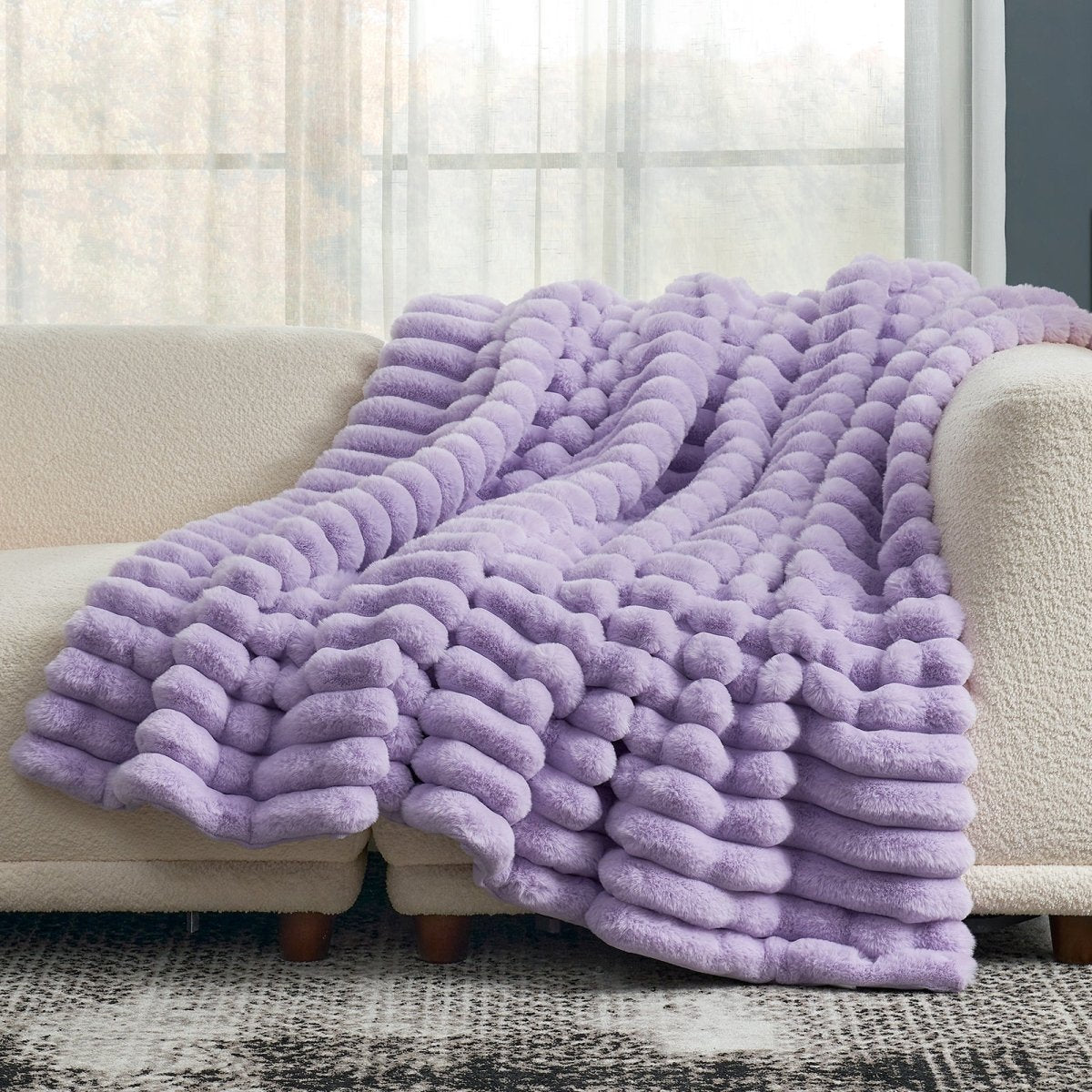 Cozy Bliss striped faux fur throw blanket draped over a sofa, soft and cozy #color_Purple