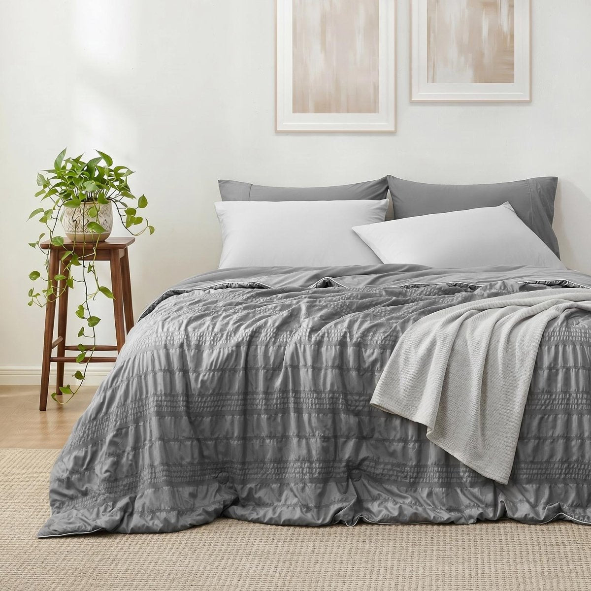 Cozy Bliss seersucker cooling comforter on a bed in front view.#color_Dark Grey