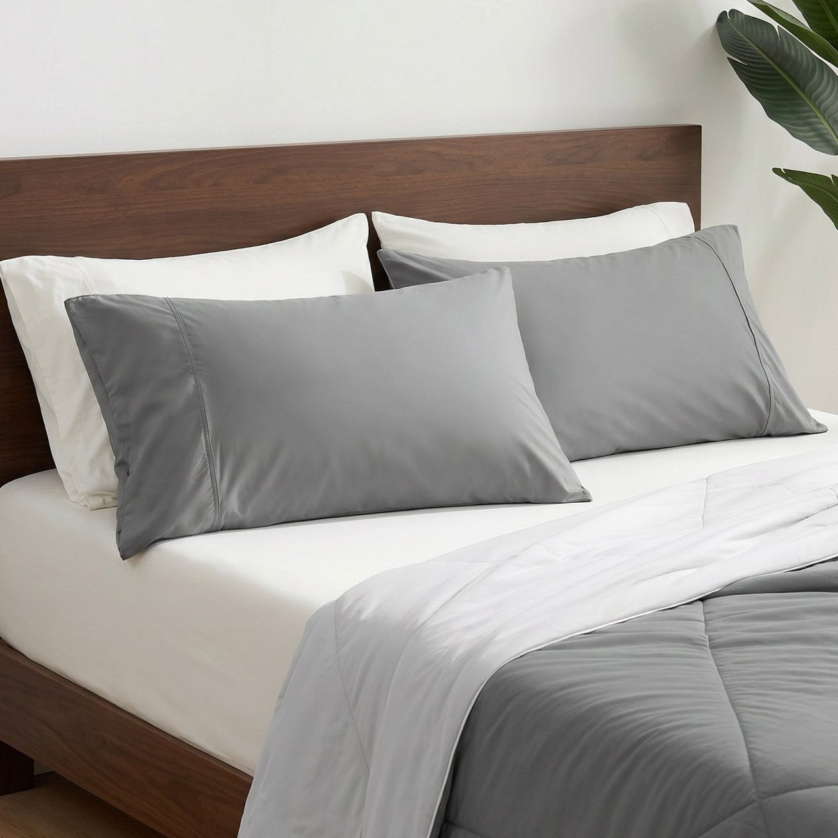 Cozy Bliss cooling pillowcases on bed in side view, ideal for cool and comfortable sleep. #color_Dark Grey