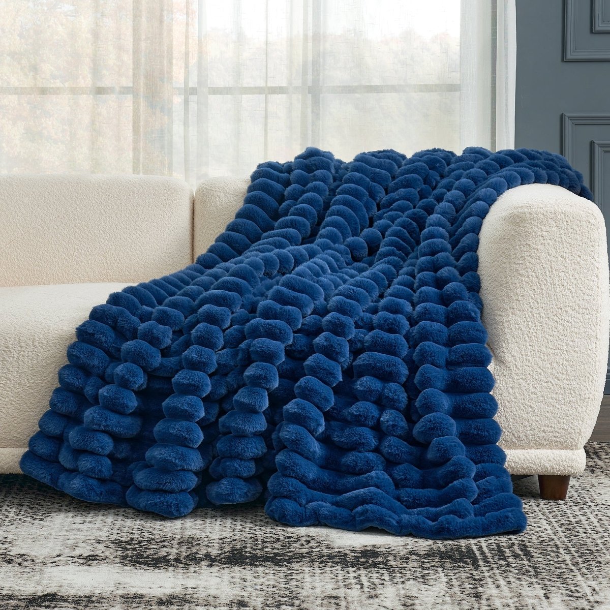 Cozy Bliss navy blue striped faux fur throw blanket draped on a sofa, offering cozy comfort and stylish design. #color_Navy Blue