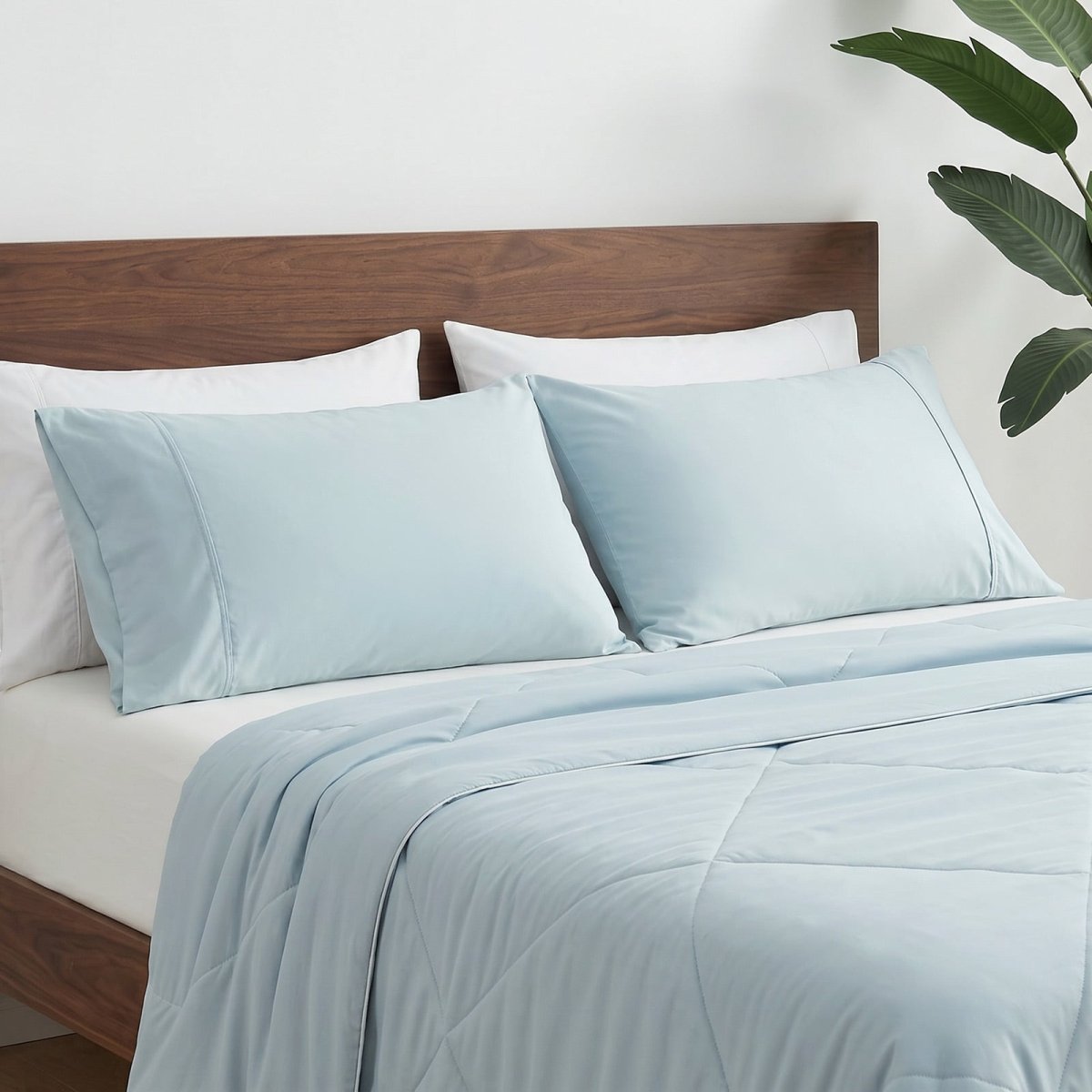 Cozy Bliss cooling pillowcases on bed in side view, ideal for cool and comfortable sleep. #color_Cool Blue